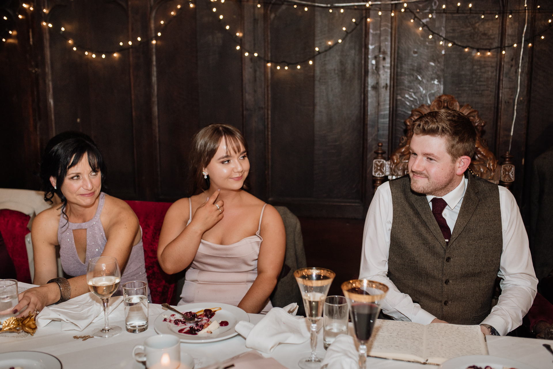 A group of people sitting at a table with food