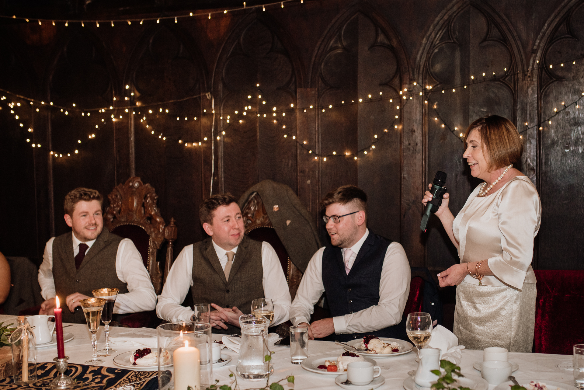 A group of people sitting at a table with food and drinks