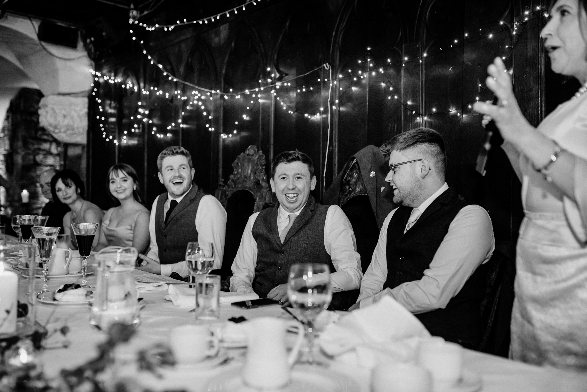 A group of people sitting around a table with glasses of wine