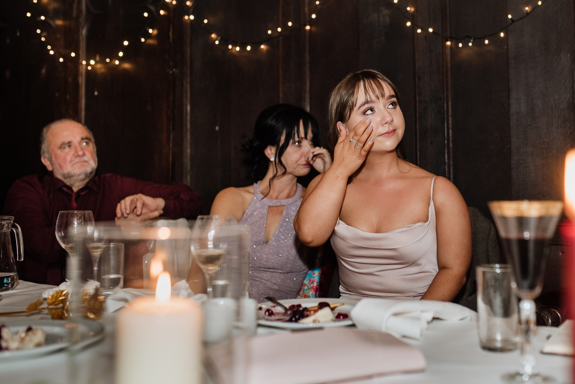 A group of people sitting at a table with food and drinks