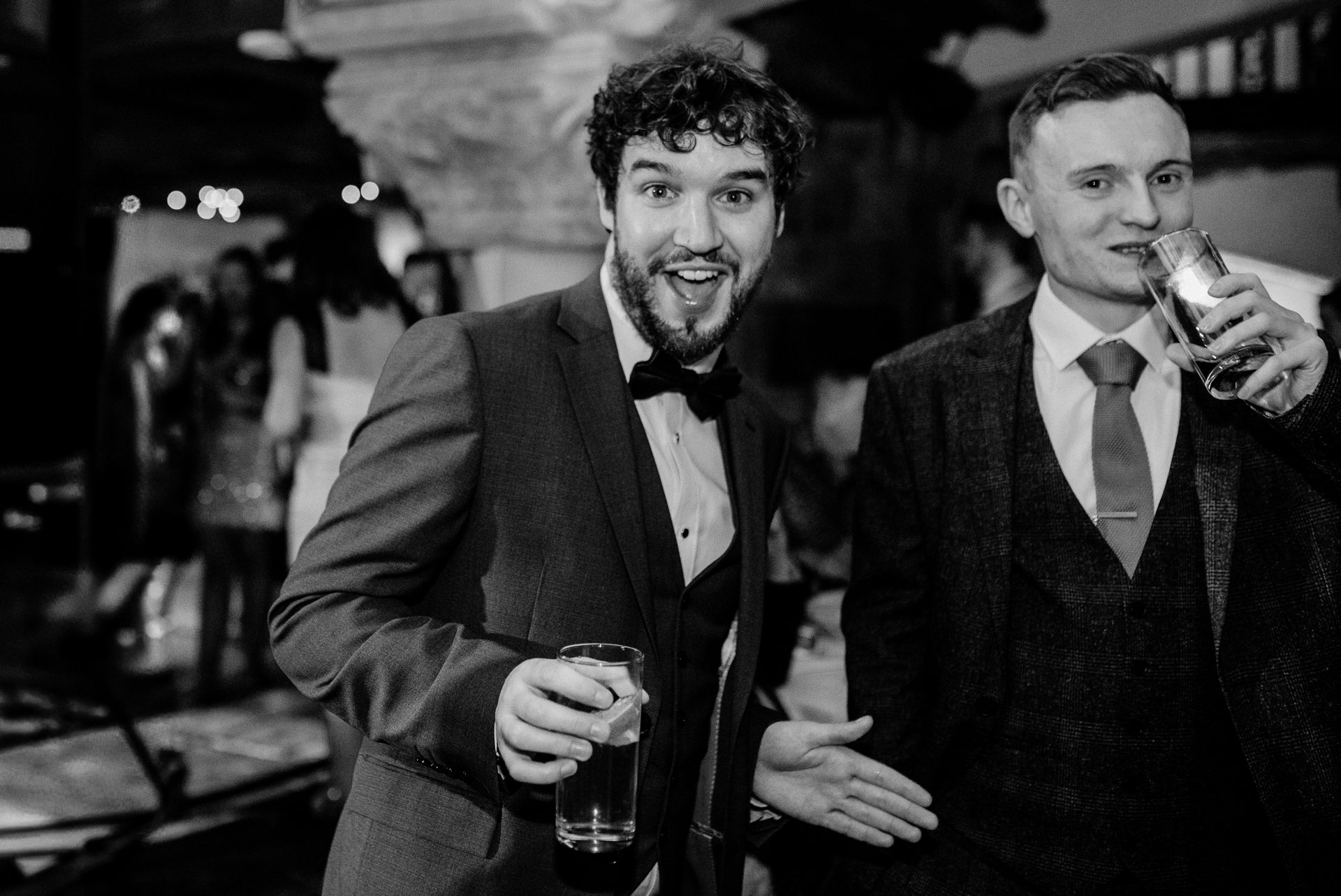 A couple of men holding glasses of beer