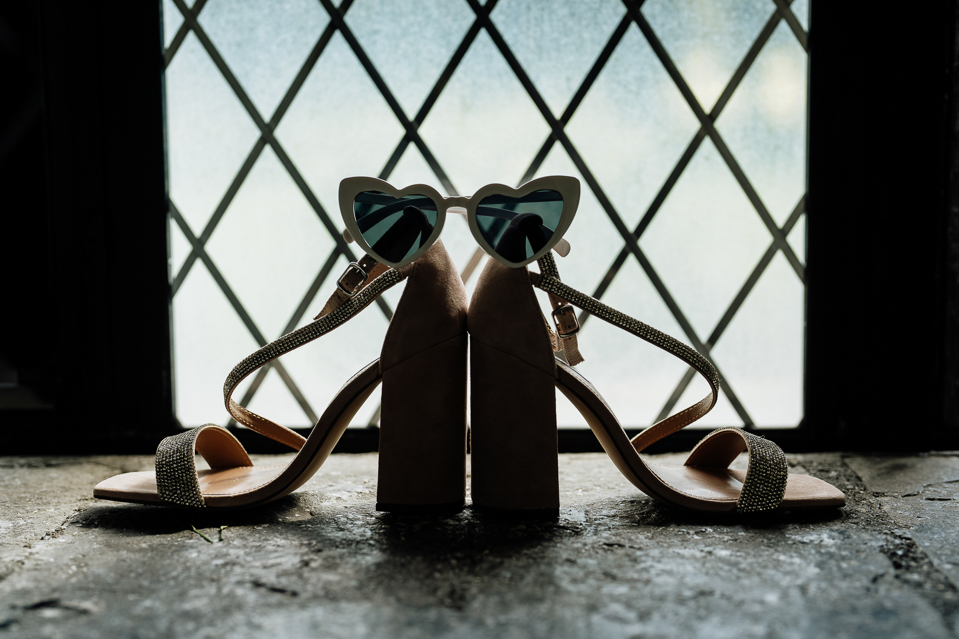 A pair of boots on a metal fence