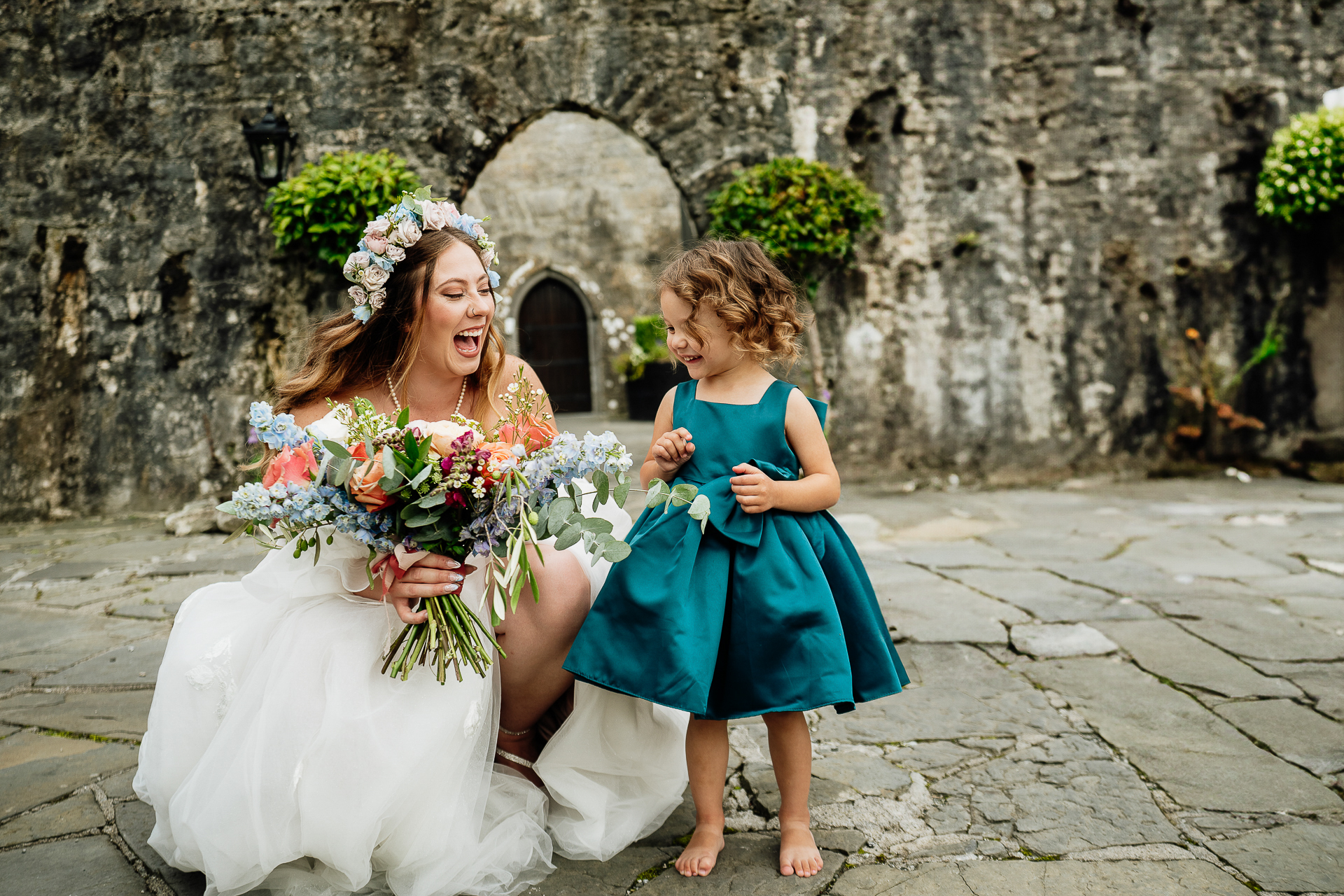 A woman in a white dress and a girl in a blue dress