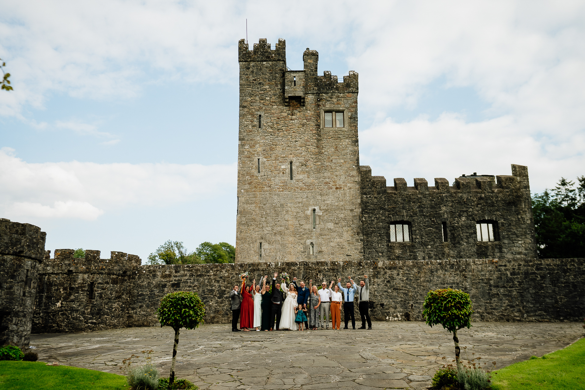 A group of people standing in front of a castle