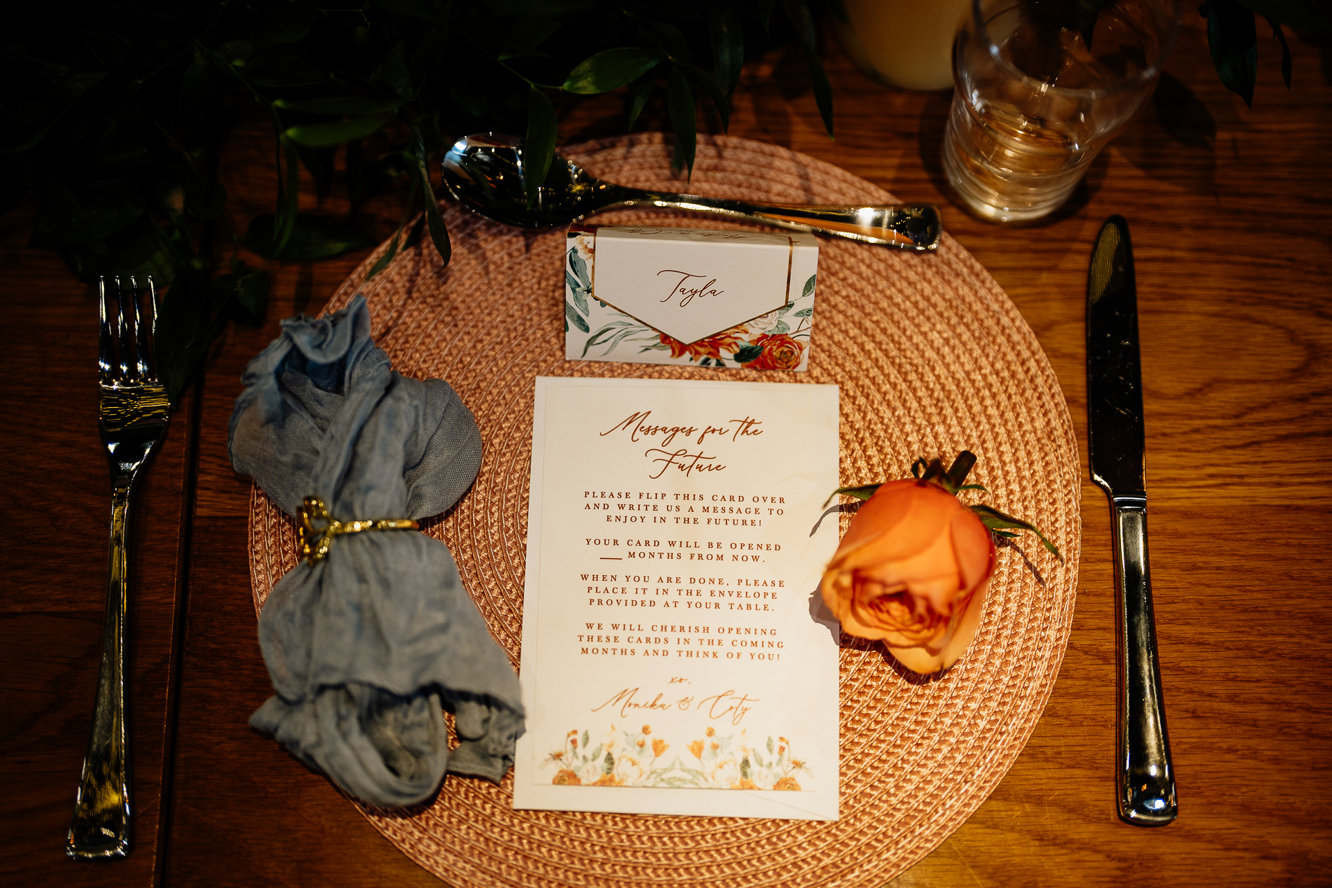 A table with a menu and a flower on it