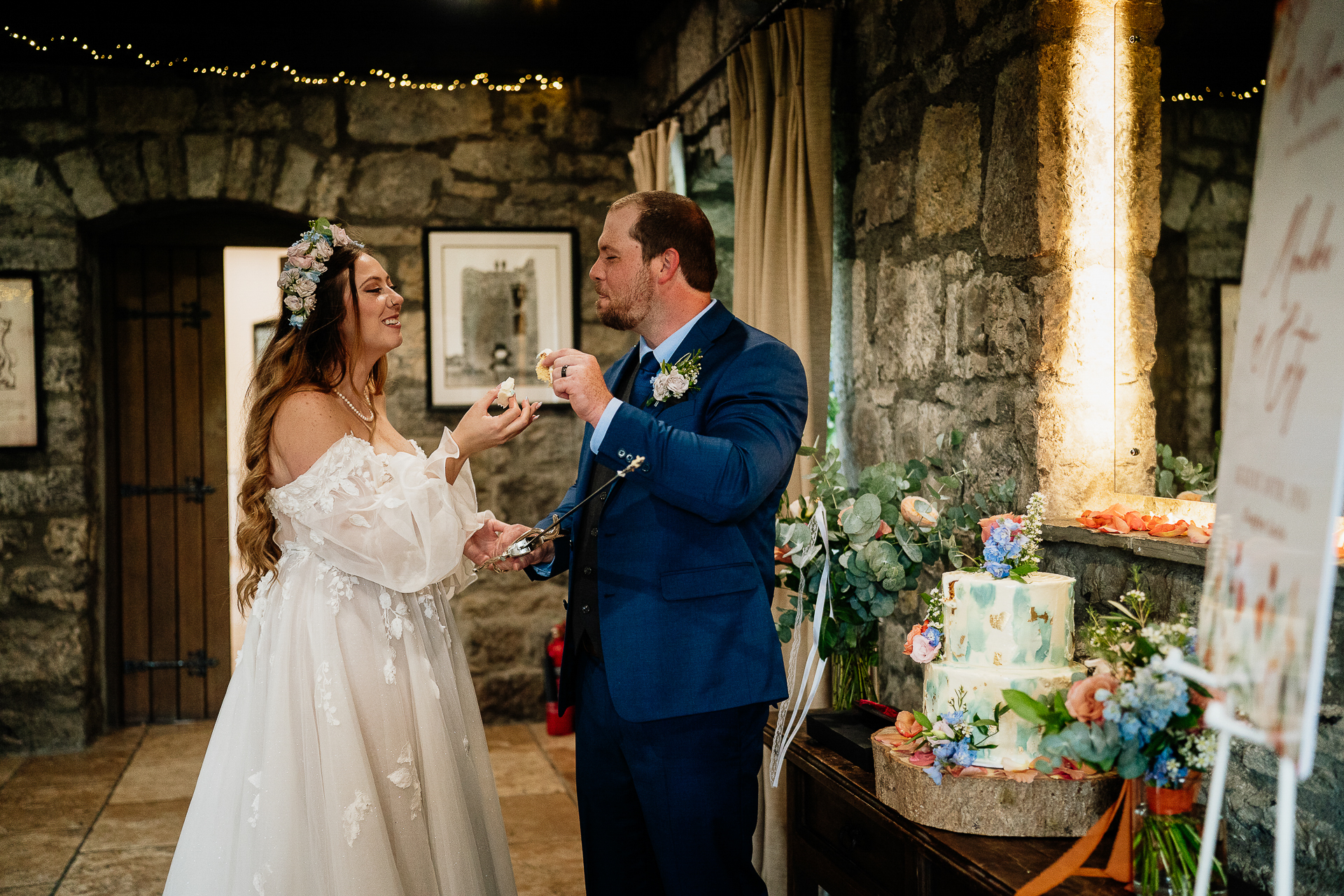 A bride and groom cutting a cake