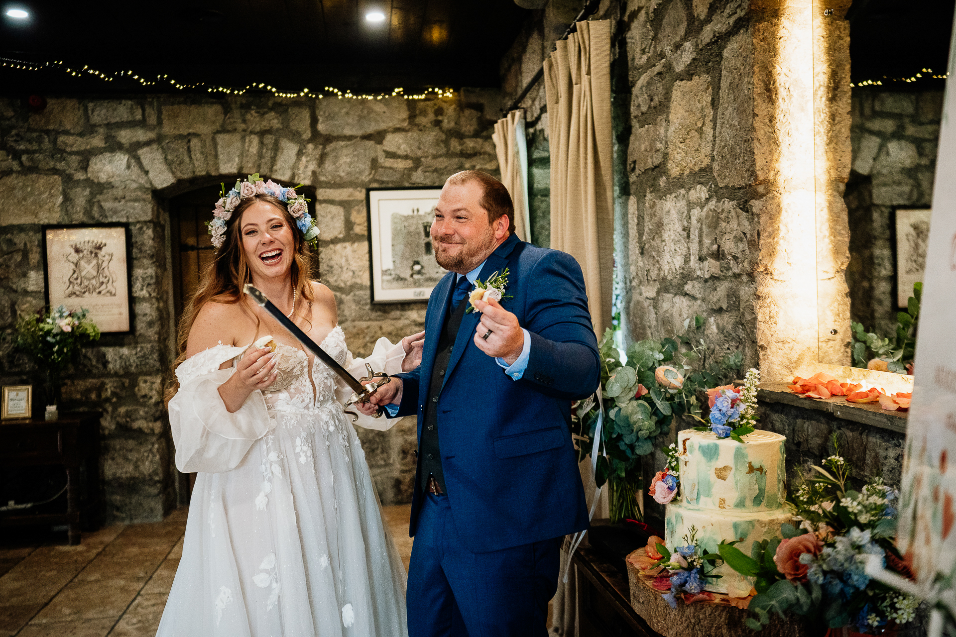 A bride and groom cutting their wedding cake