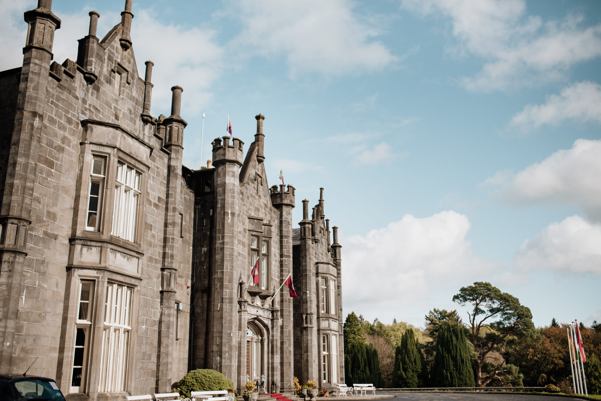 A large stone building with flags on it