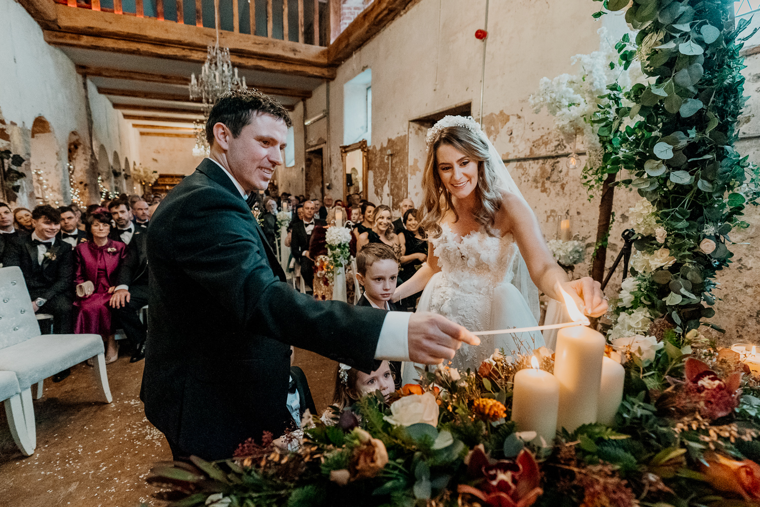 A bride and groom cutting a cake