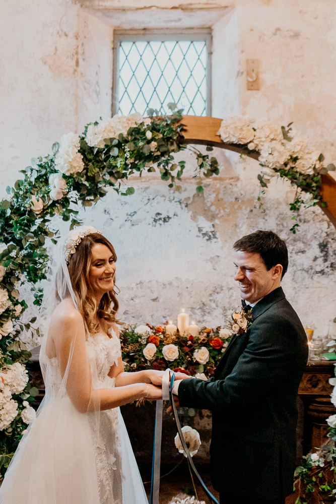 A bride and groom holding hands