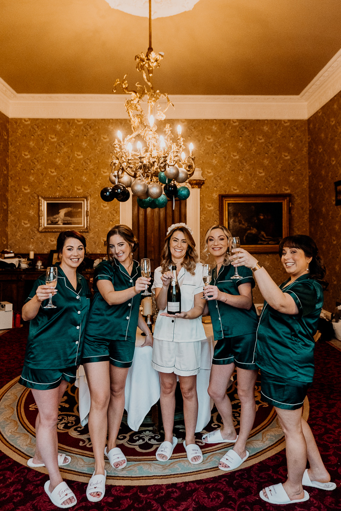 A group of women in green dresses holding wine glasses