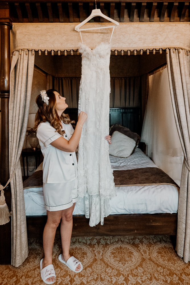 A person standing next to a bed