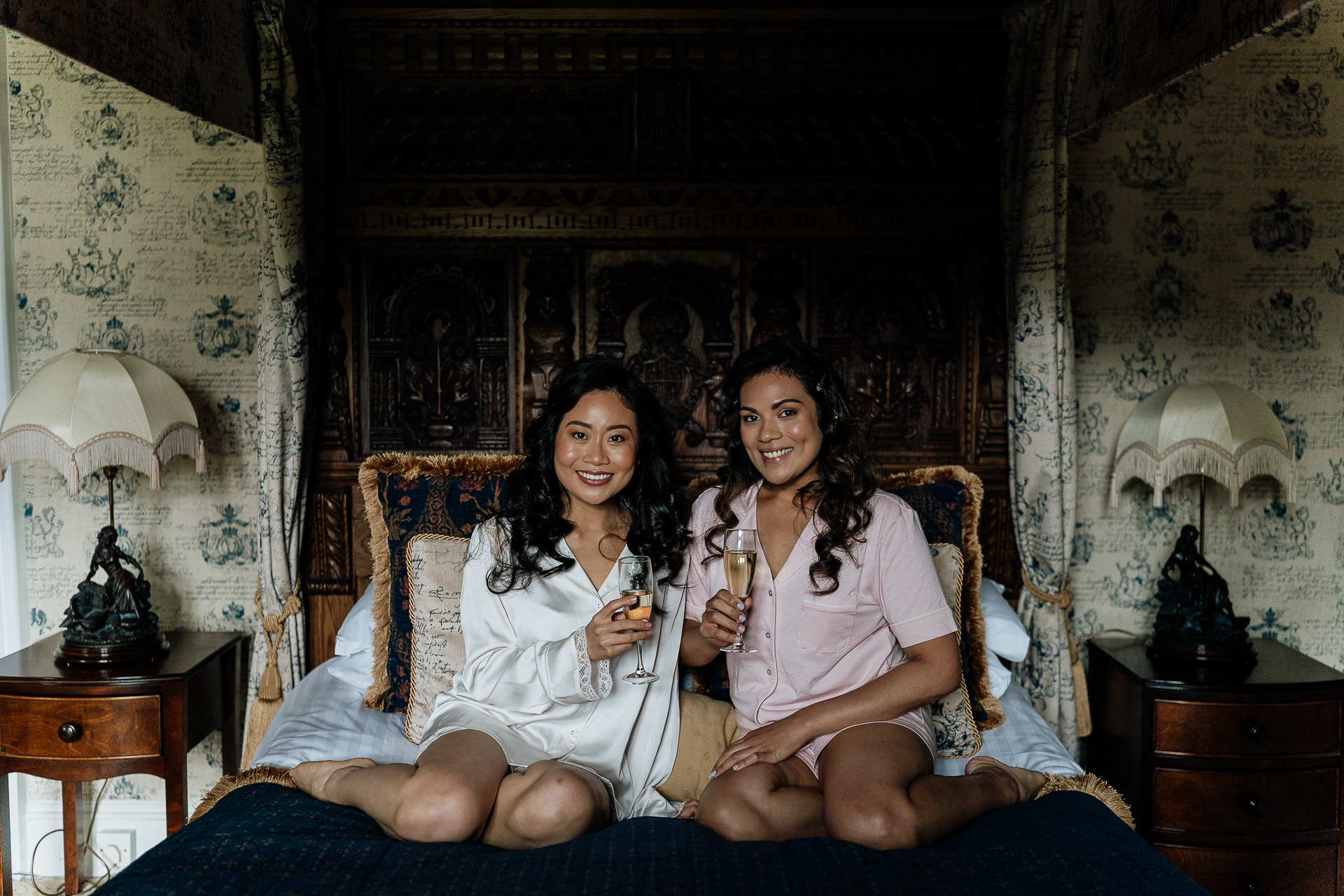 Two women sitting on a bed