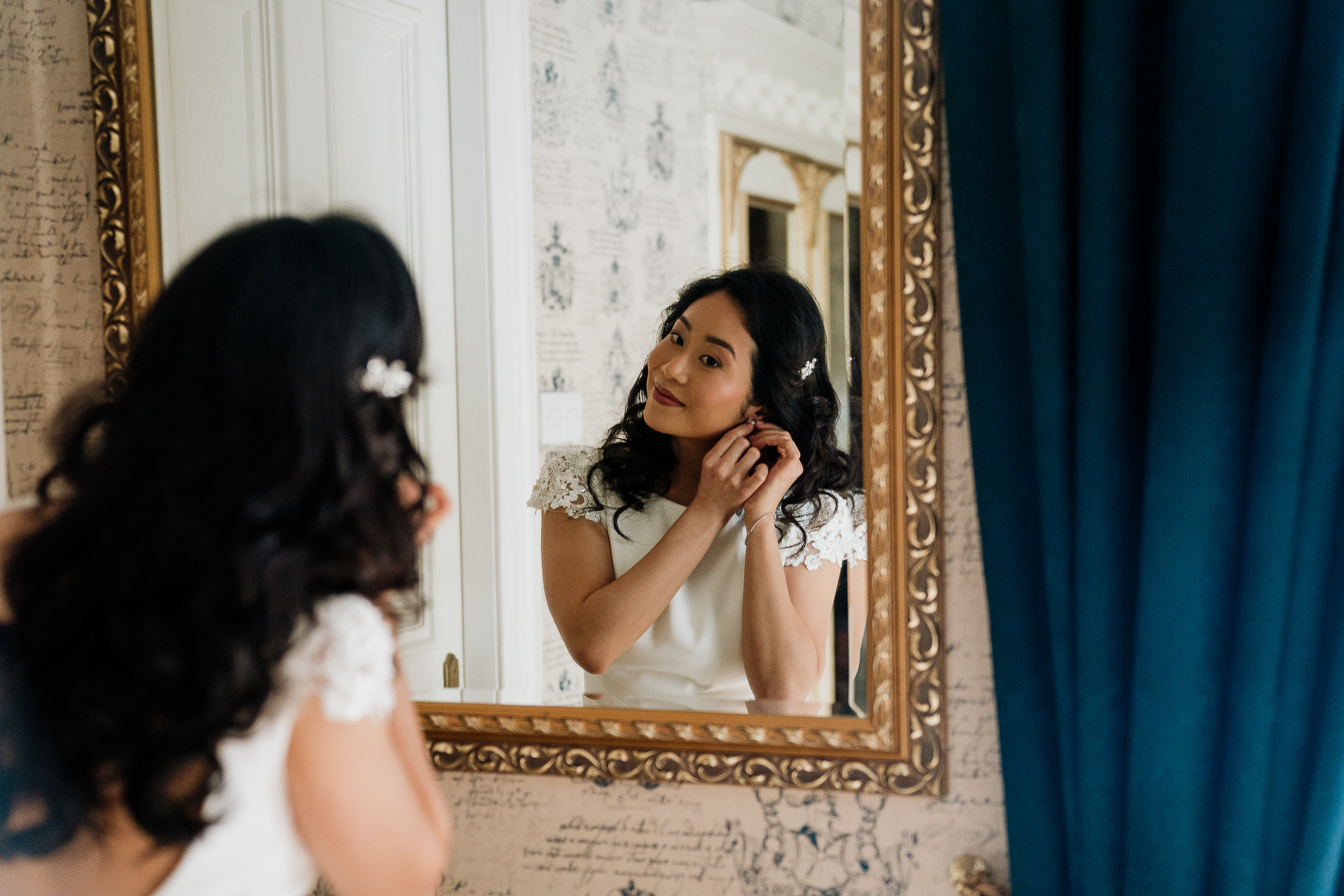 A person in a white dress in front of a mirror