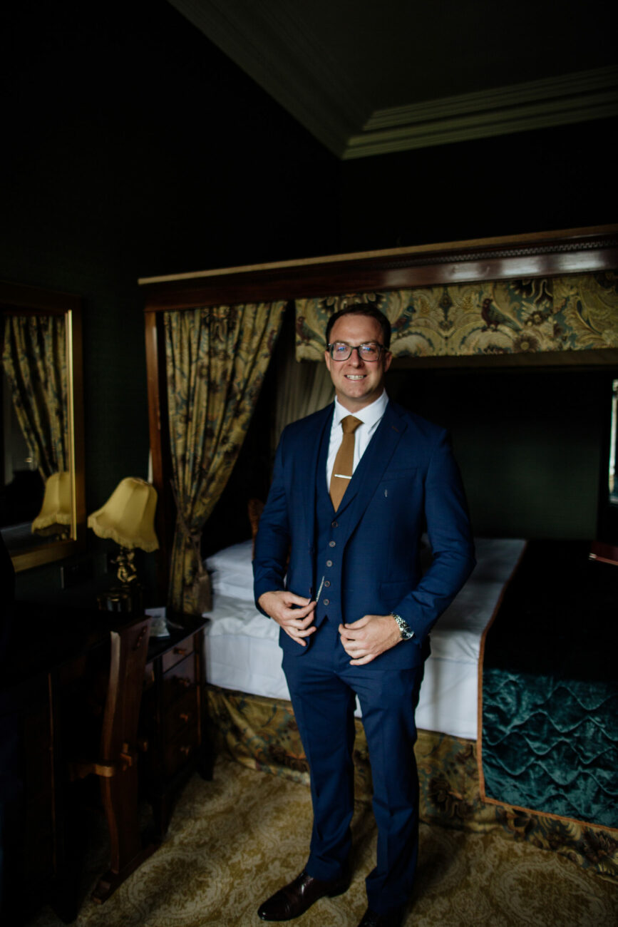 A man in a suit standing in a room