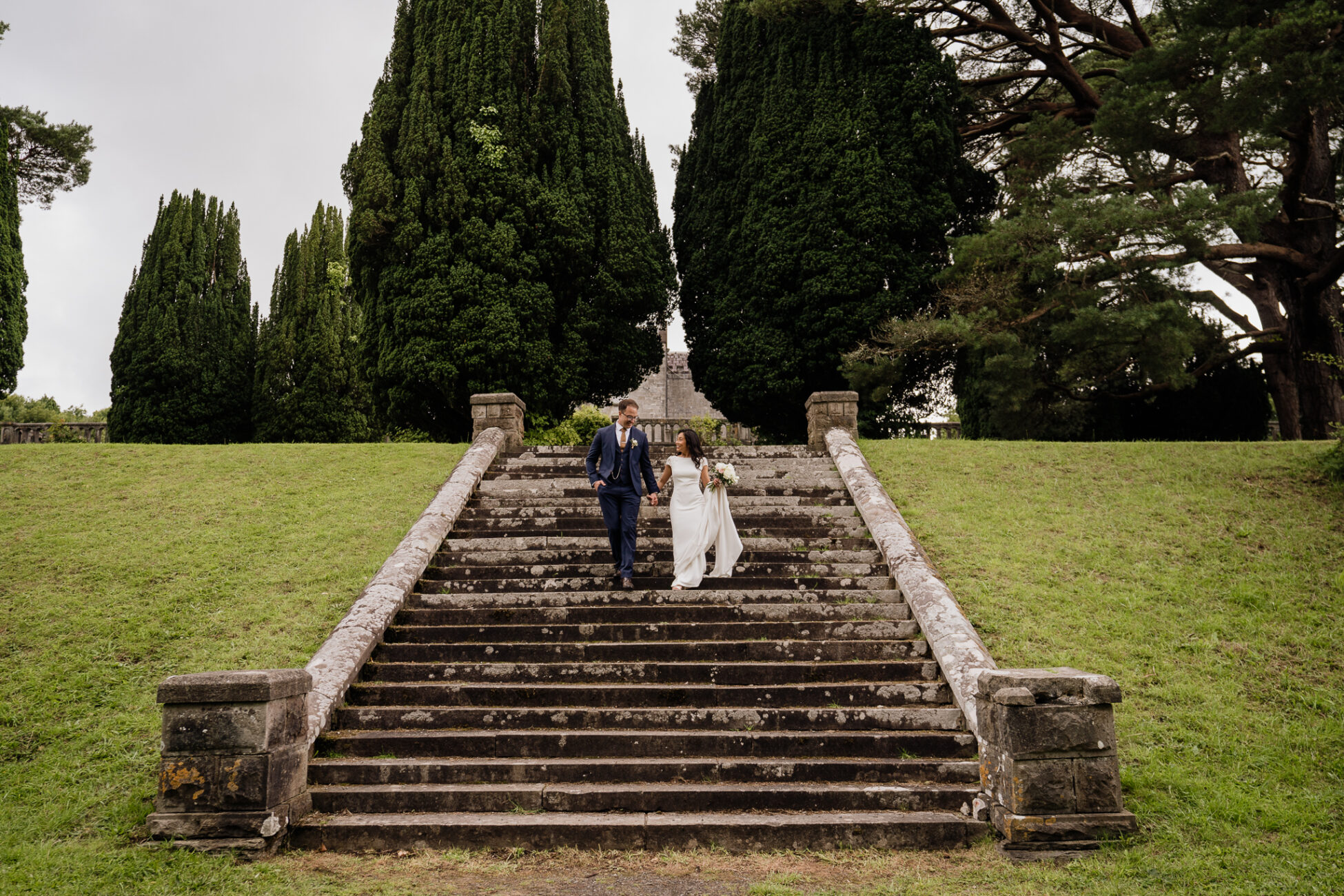 A man and woman walking down a flight of stairs