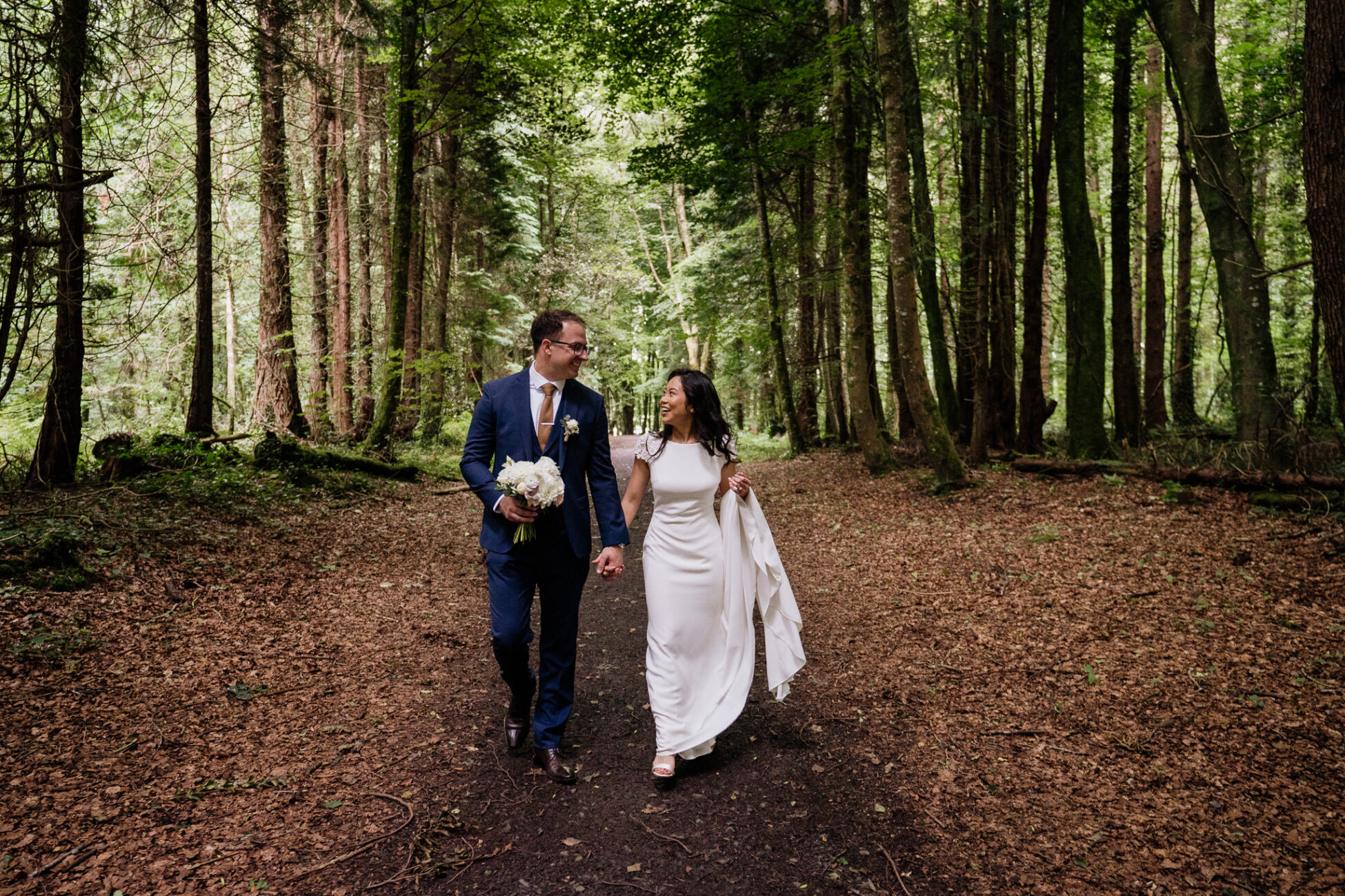 A man and woman walking in the woods