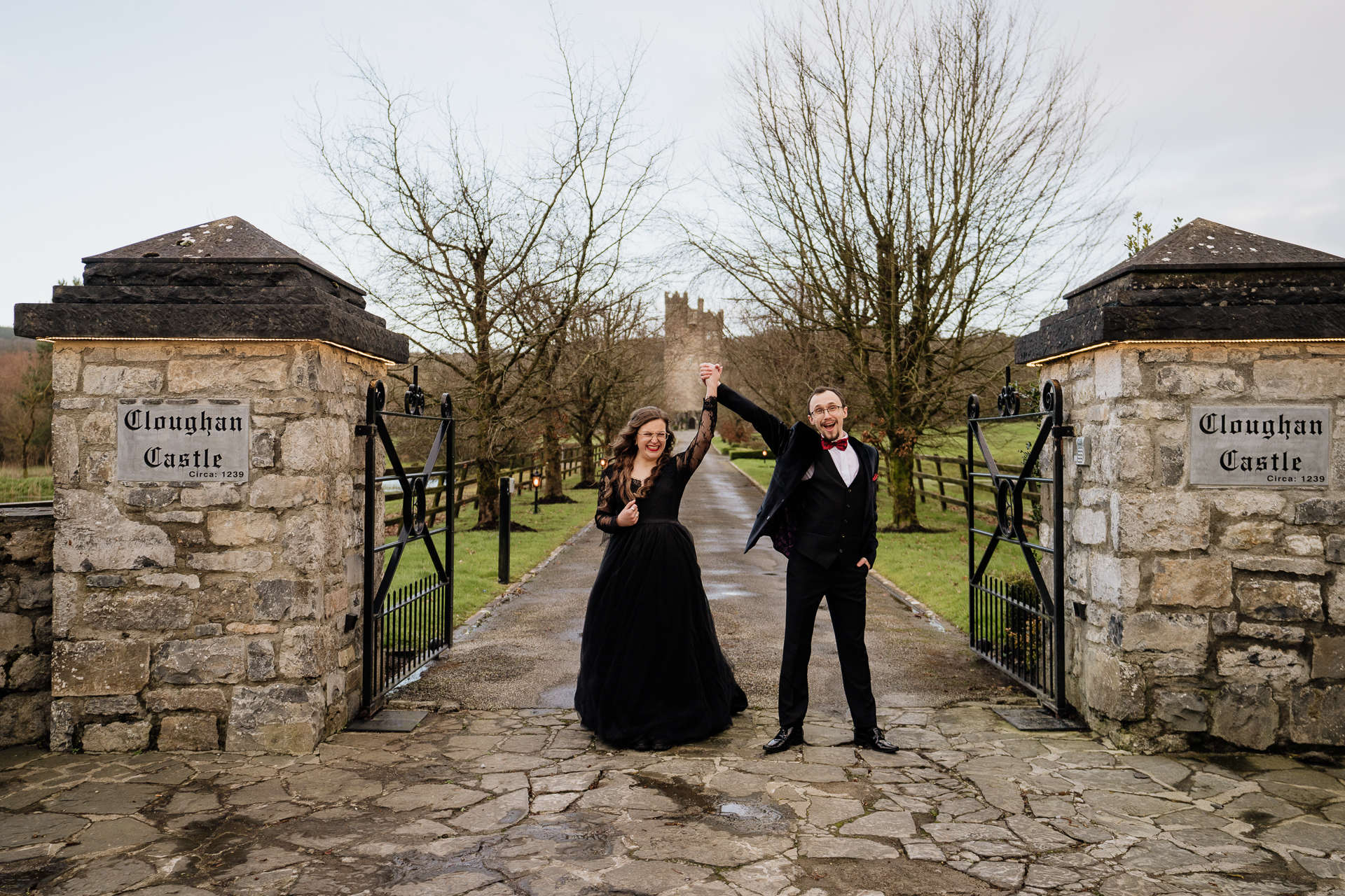 A man and woman posing for a picture on a stone path