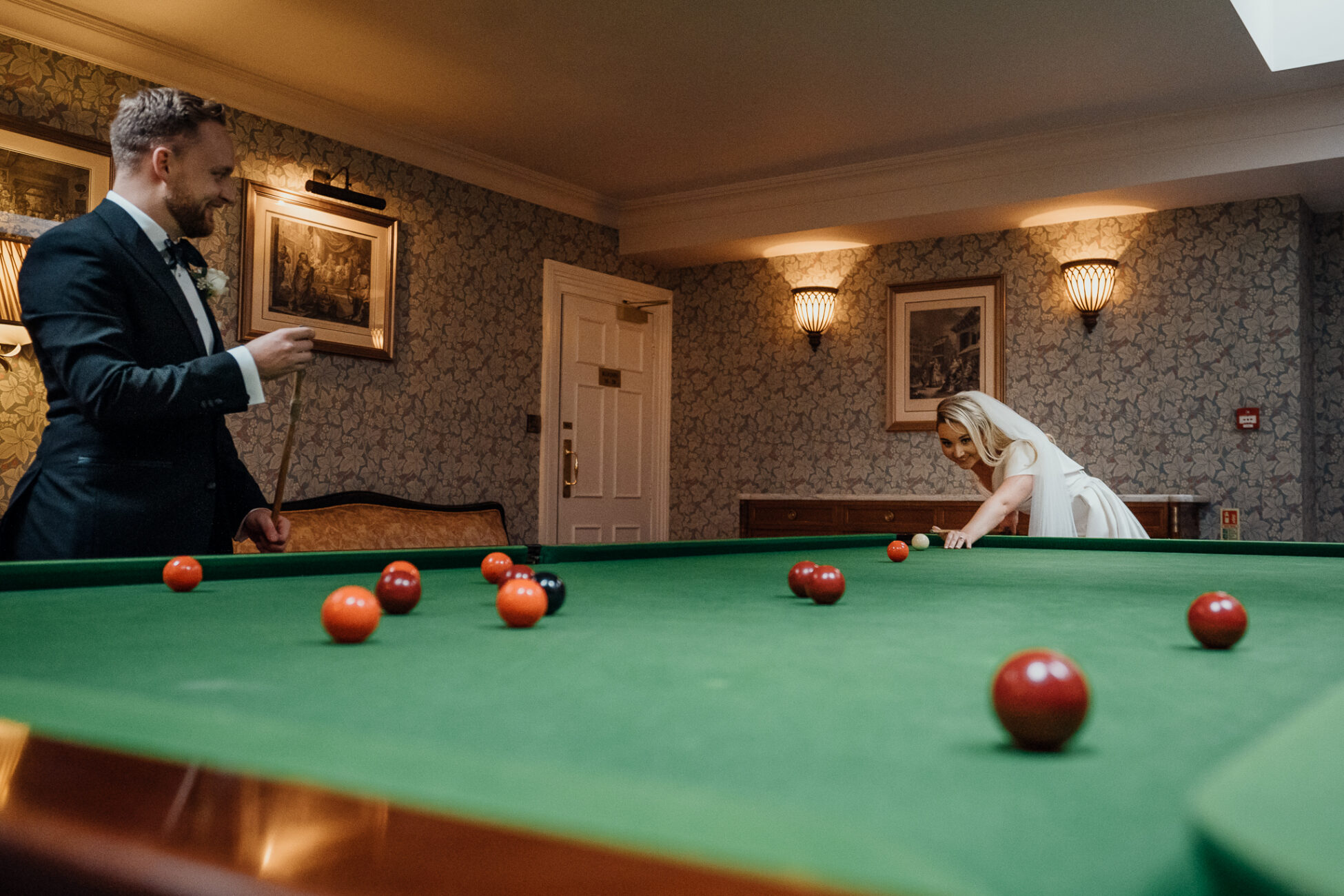 A man and a woman playing pool