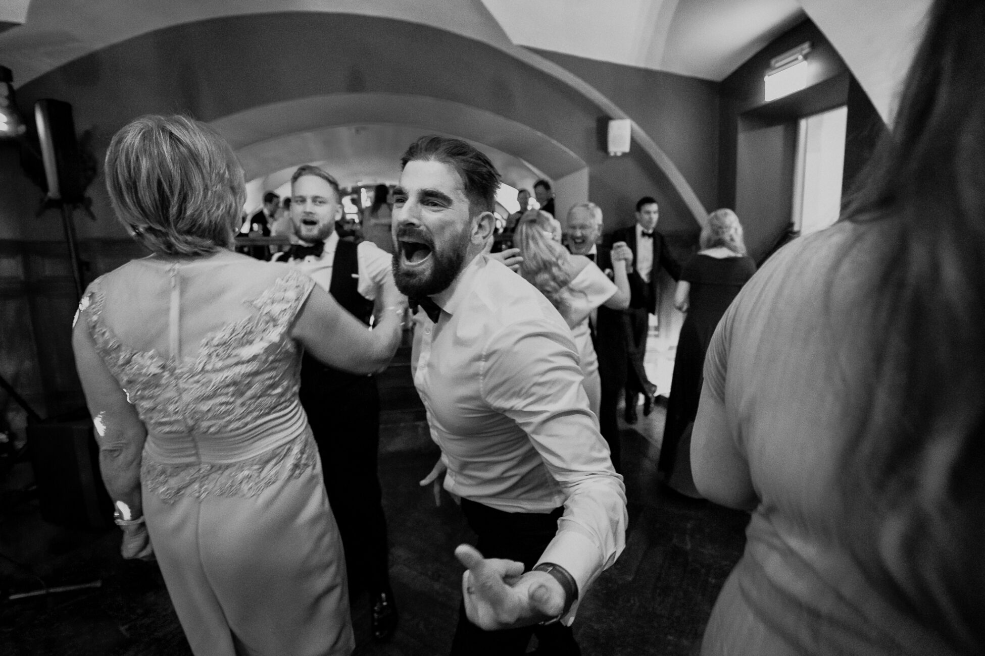 A man in a tuxedo dancing with a woman in a dress