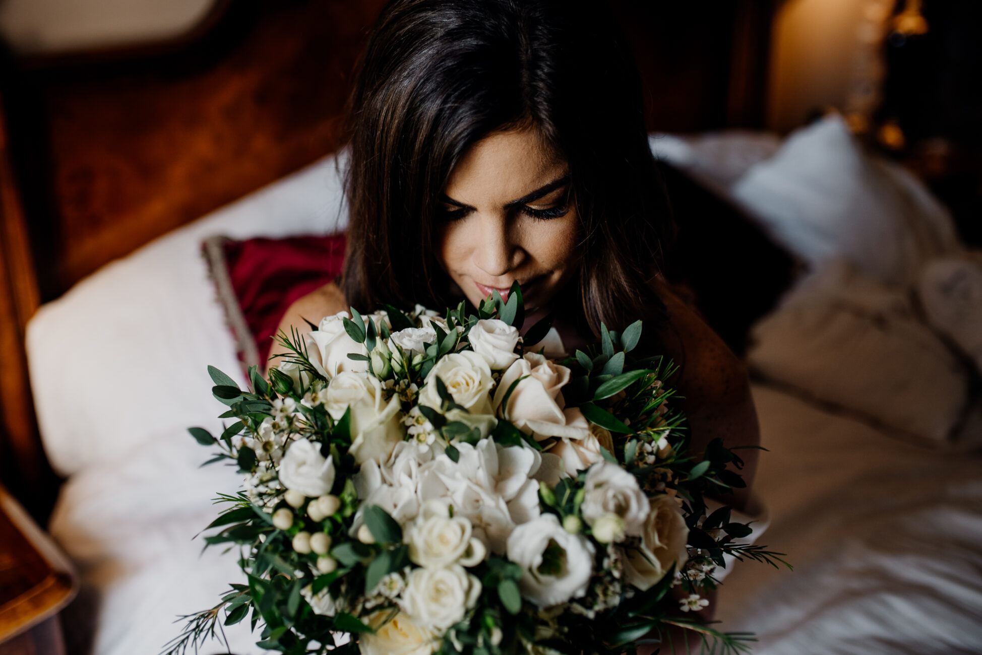 A woman holding a bouquet of white flowers