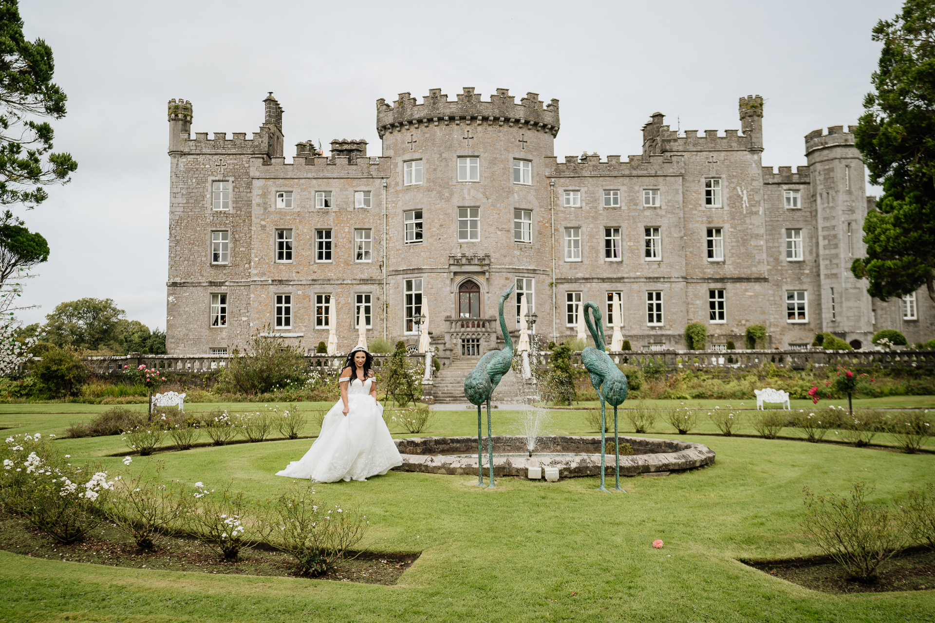 A person in a wedding dress in front of a large building