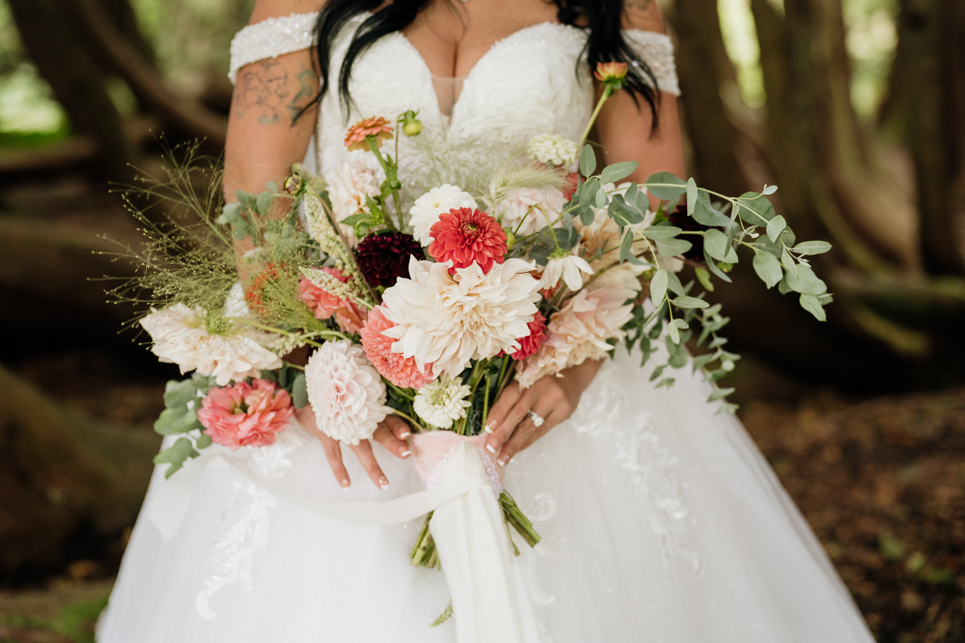 A person in a white dress holding a bouquet of flowers