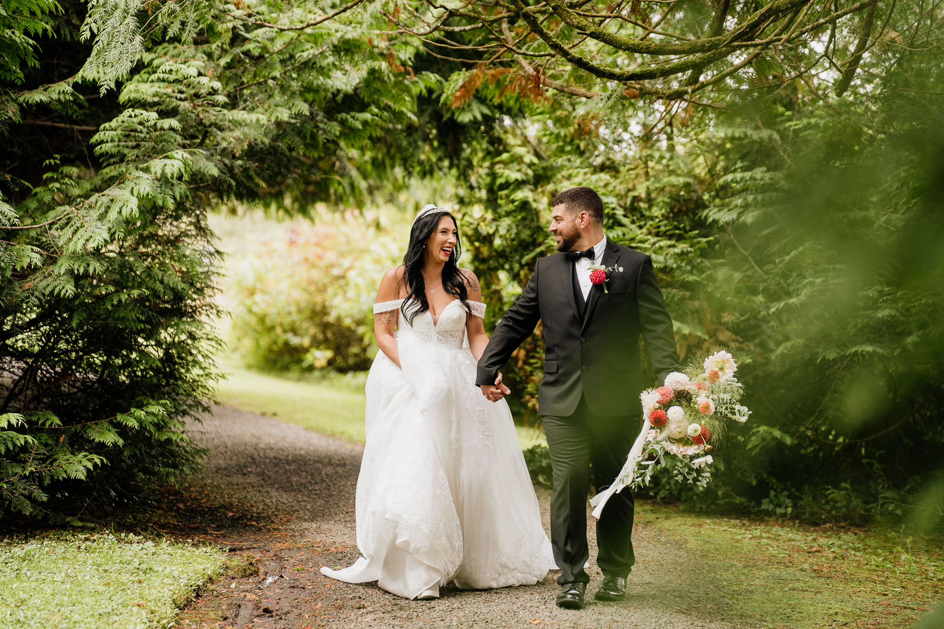 A man and woman walking down a path with flowers