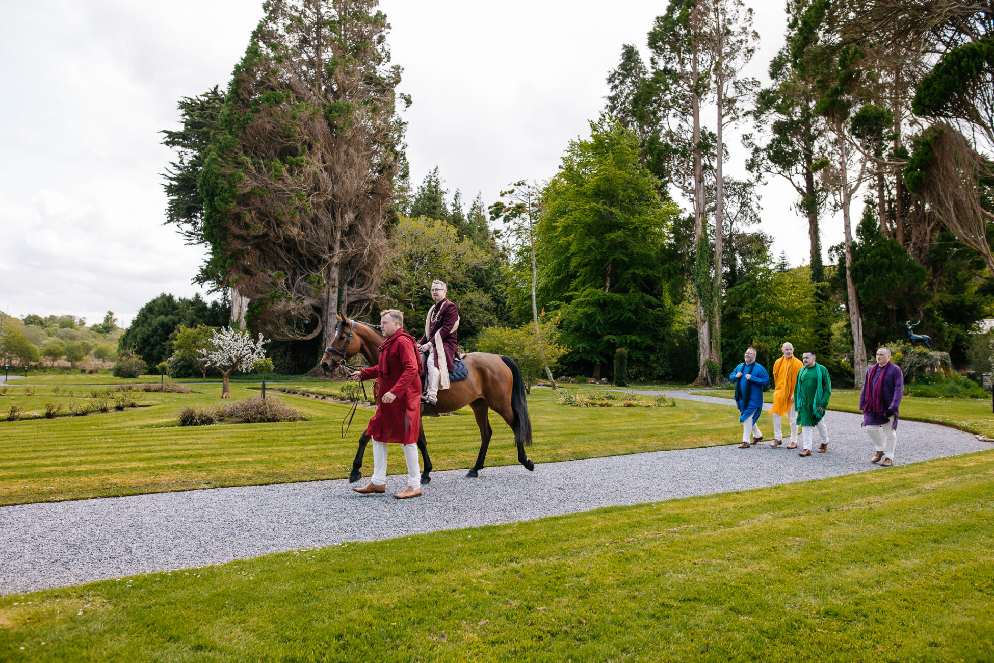 A group of people walking a horse