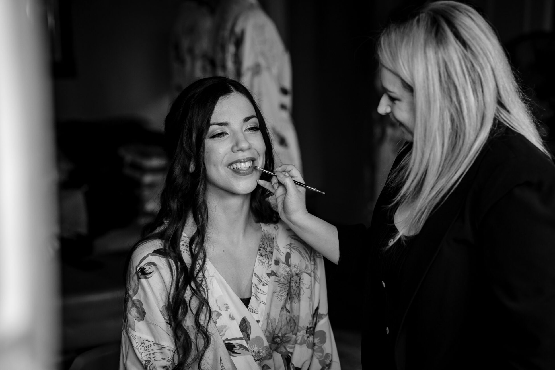 A woman smoking a cigarette next to another woman