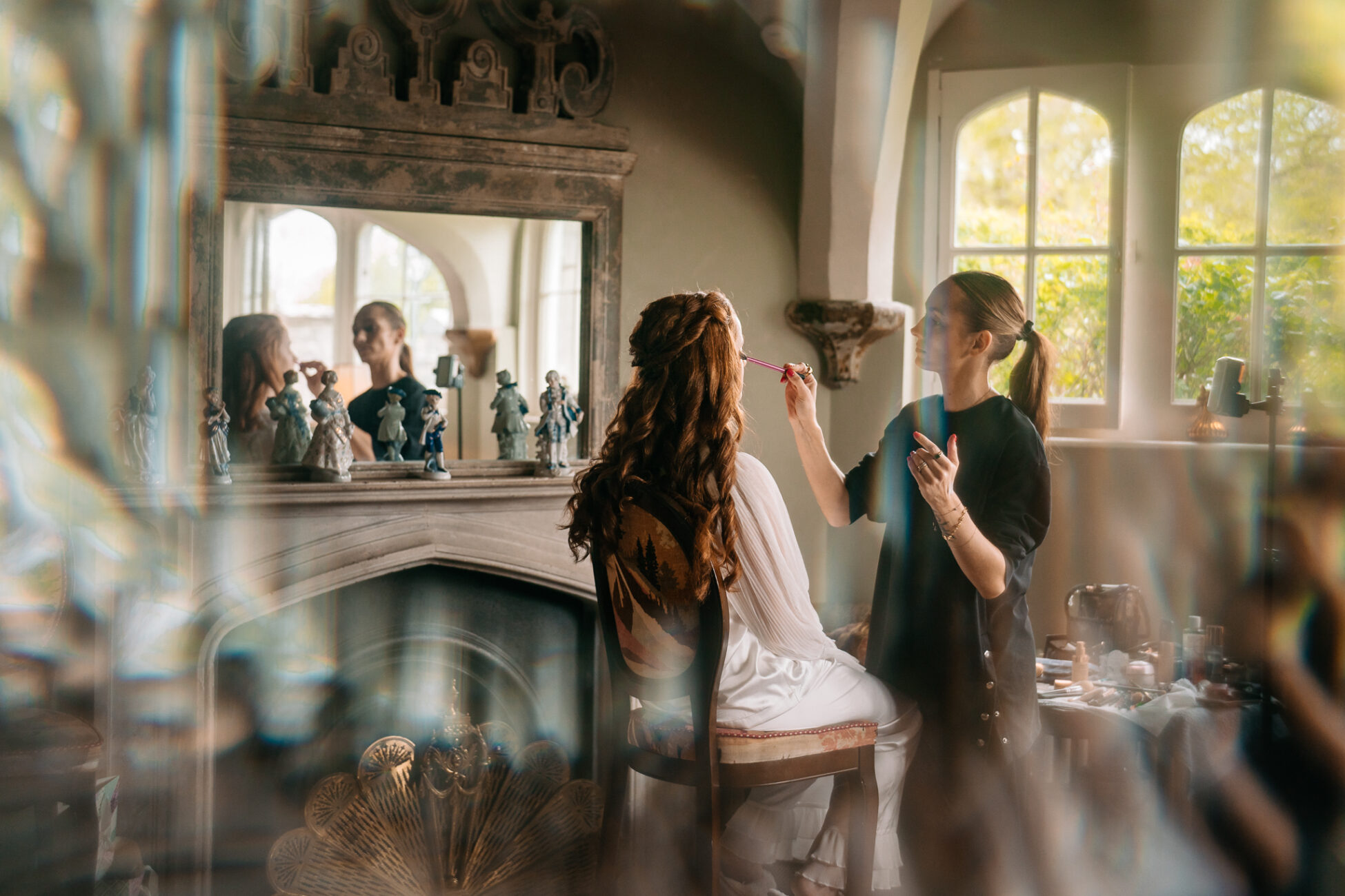 A woman brushing another woman's hair