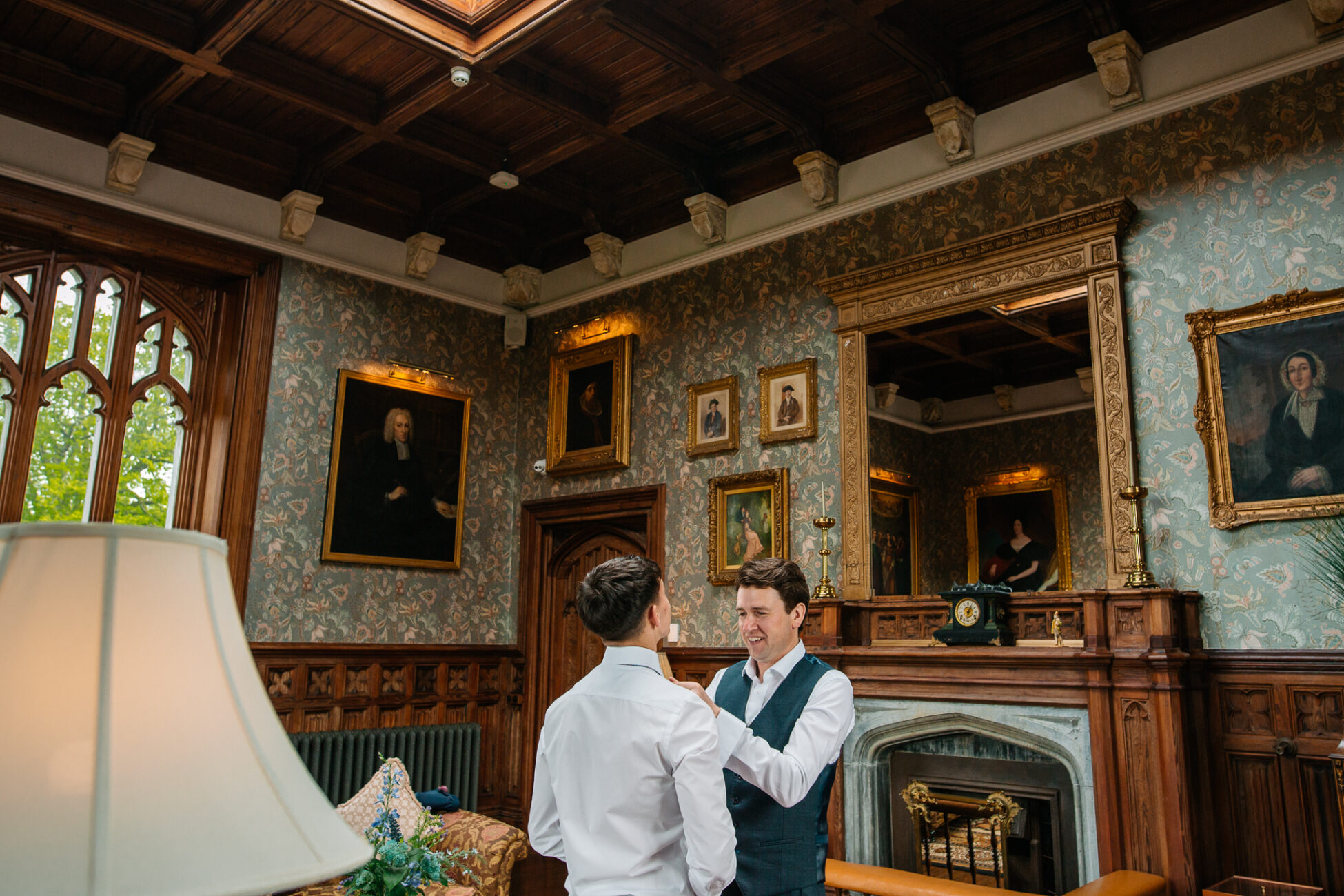 A man and a woman standing in a room with art on the walls