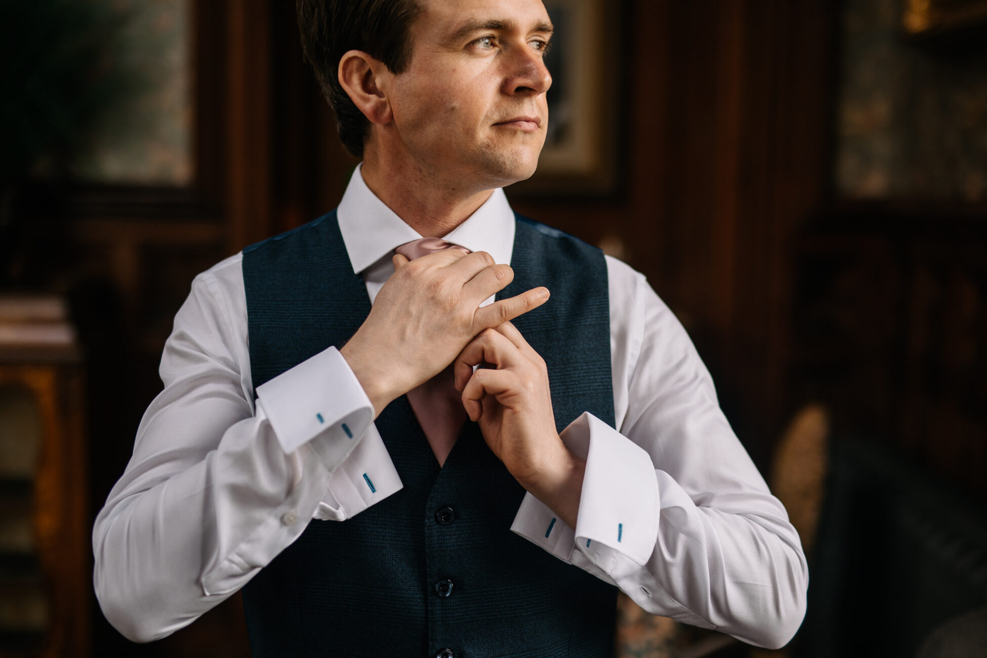 A man adjusting his tie