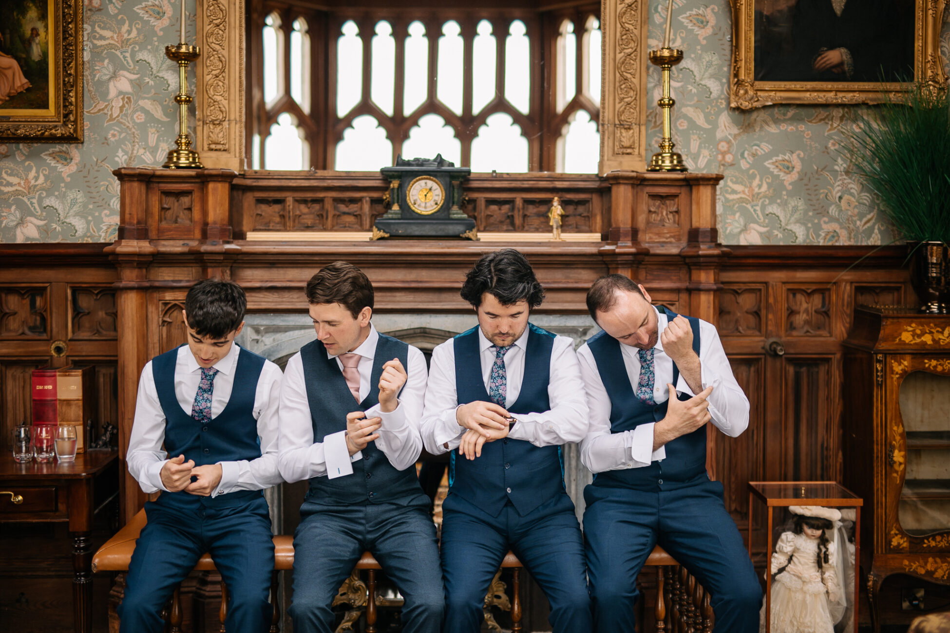 A group of men in suits sitting on a bench