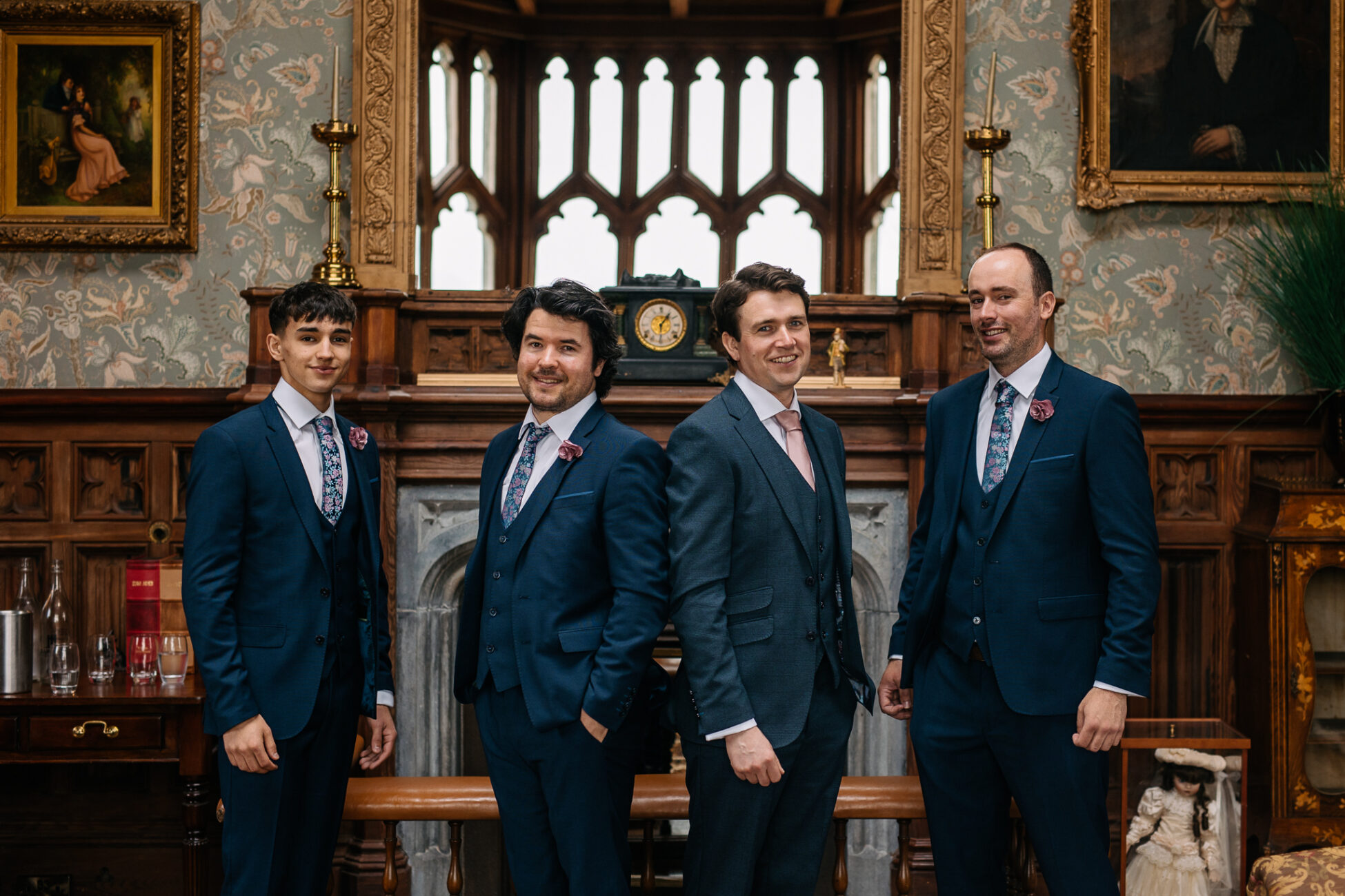 A group of men in suits standing in front of a wall with art