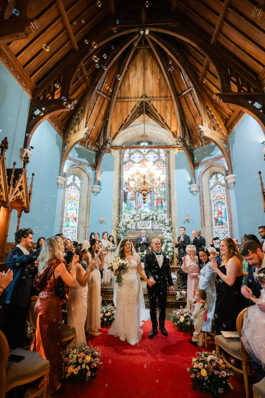 A bride and groom walking down the aisle