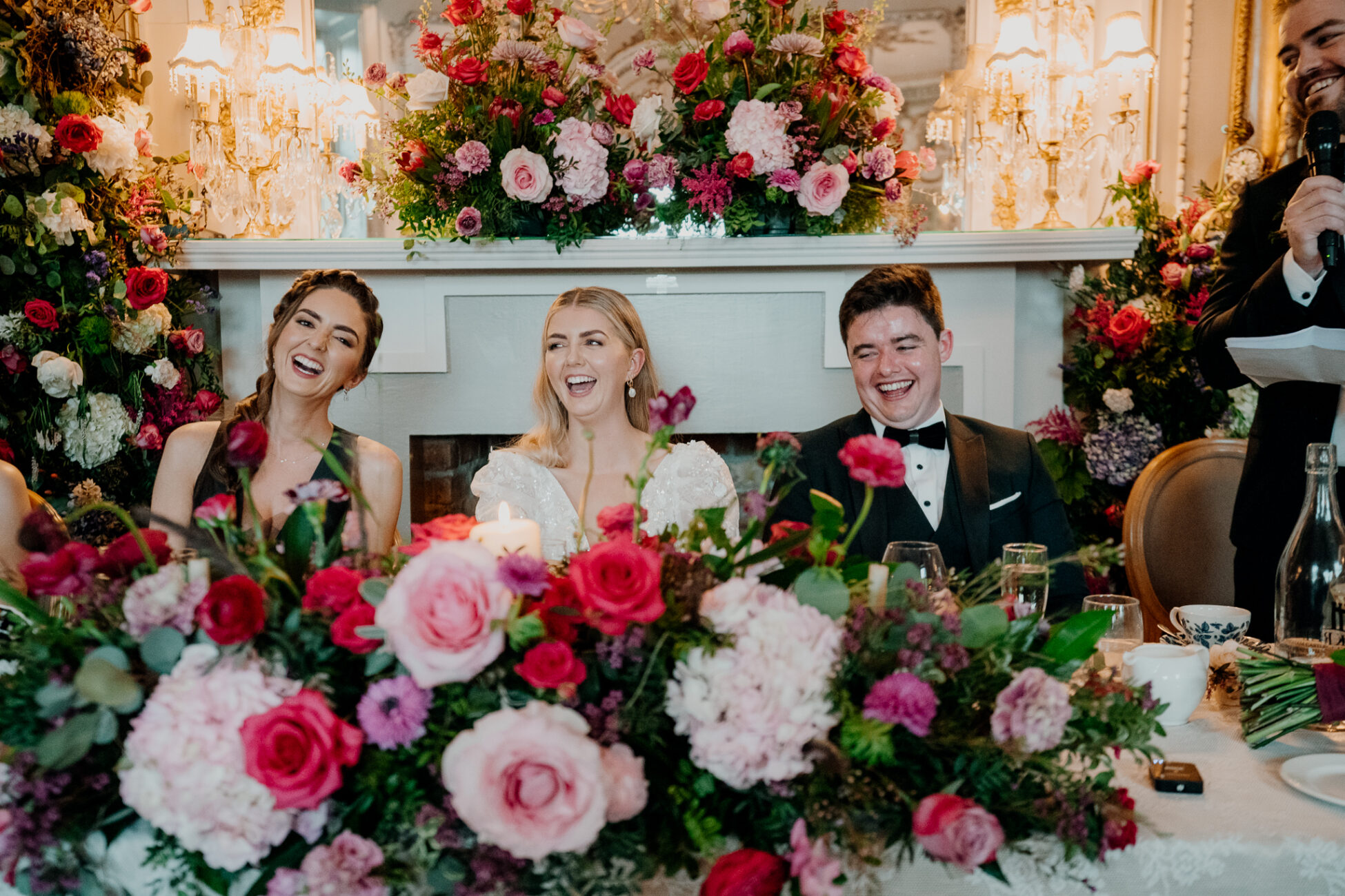 A group of people sitting at a table with flowers