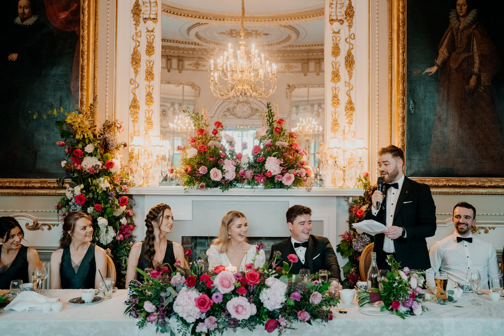 A group of people sitting at a table with flowers