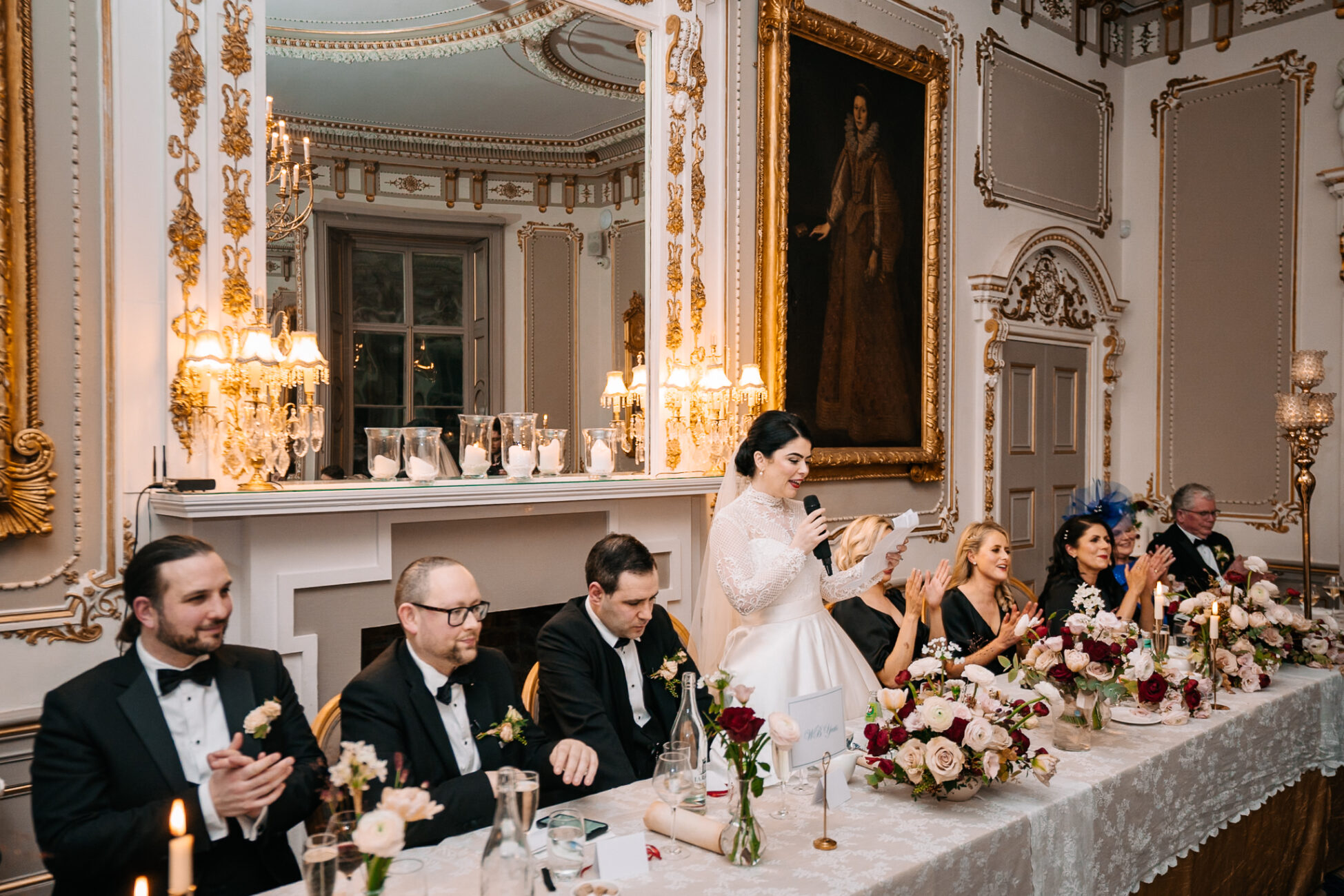 A group of people sitting at a table with flowers