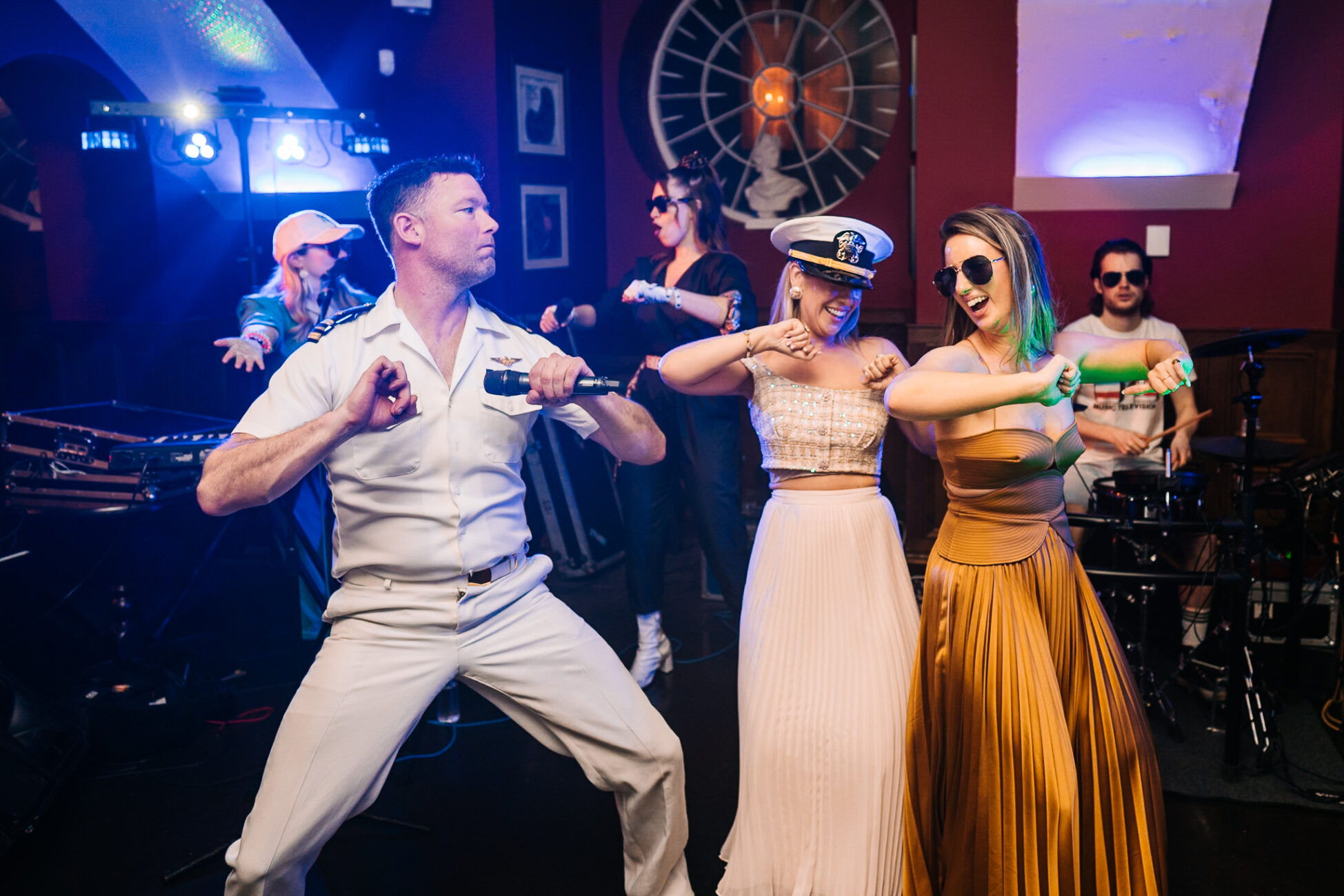 A man dancing with a group of women