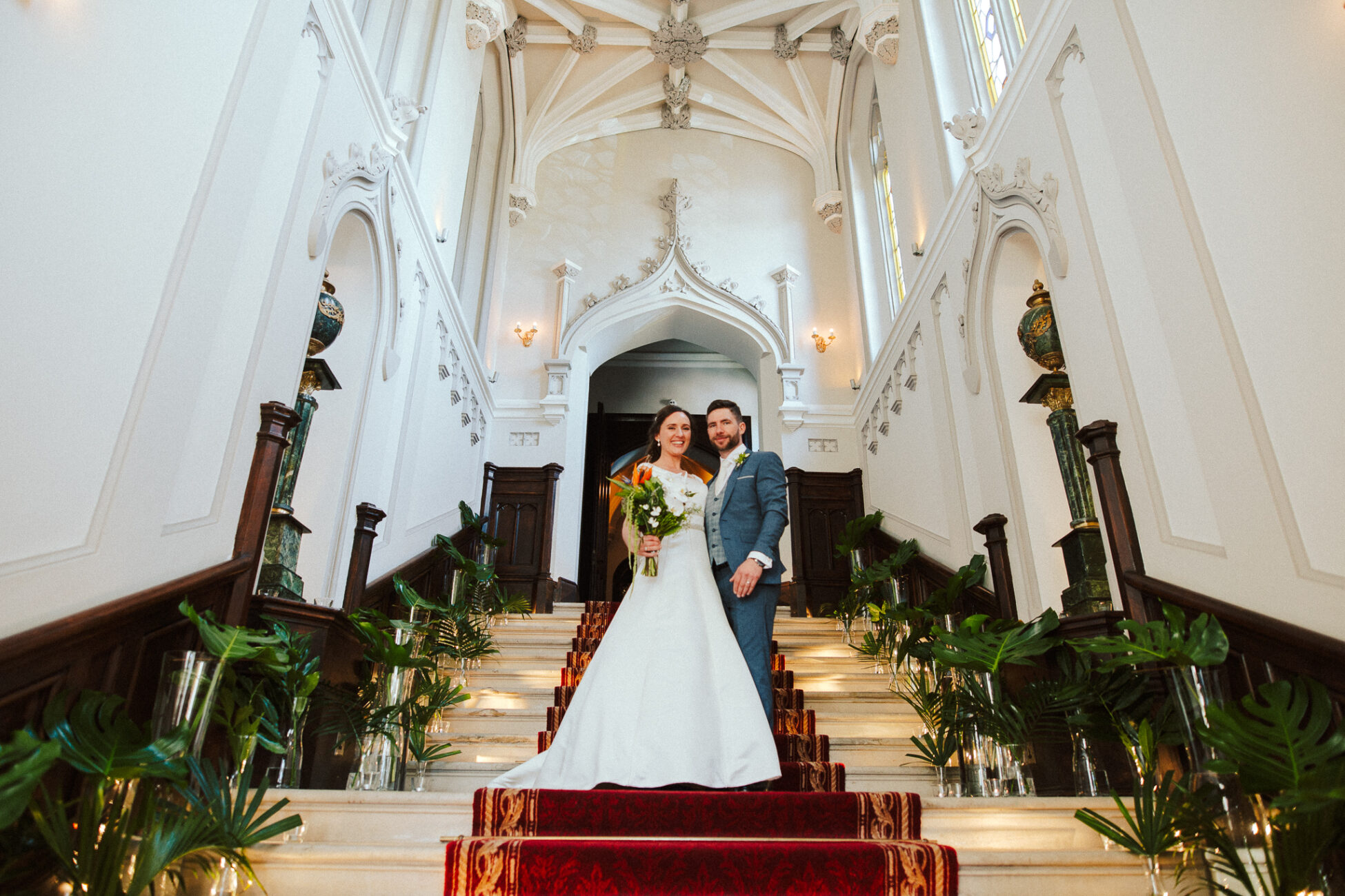 A man and woman posing for a picture on a staircase