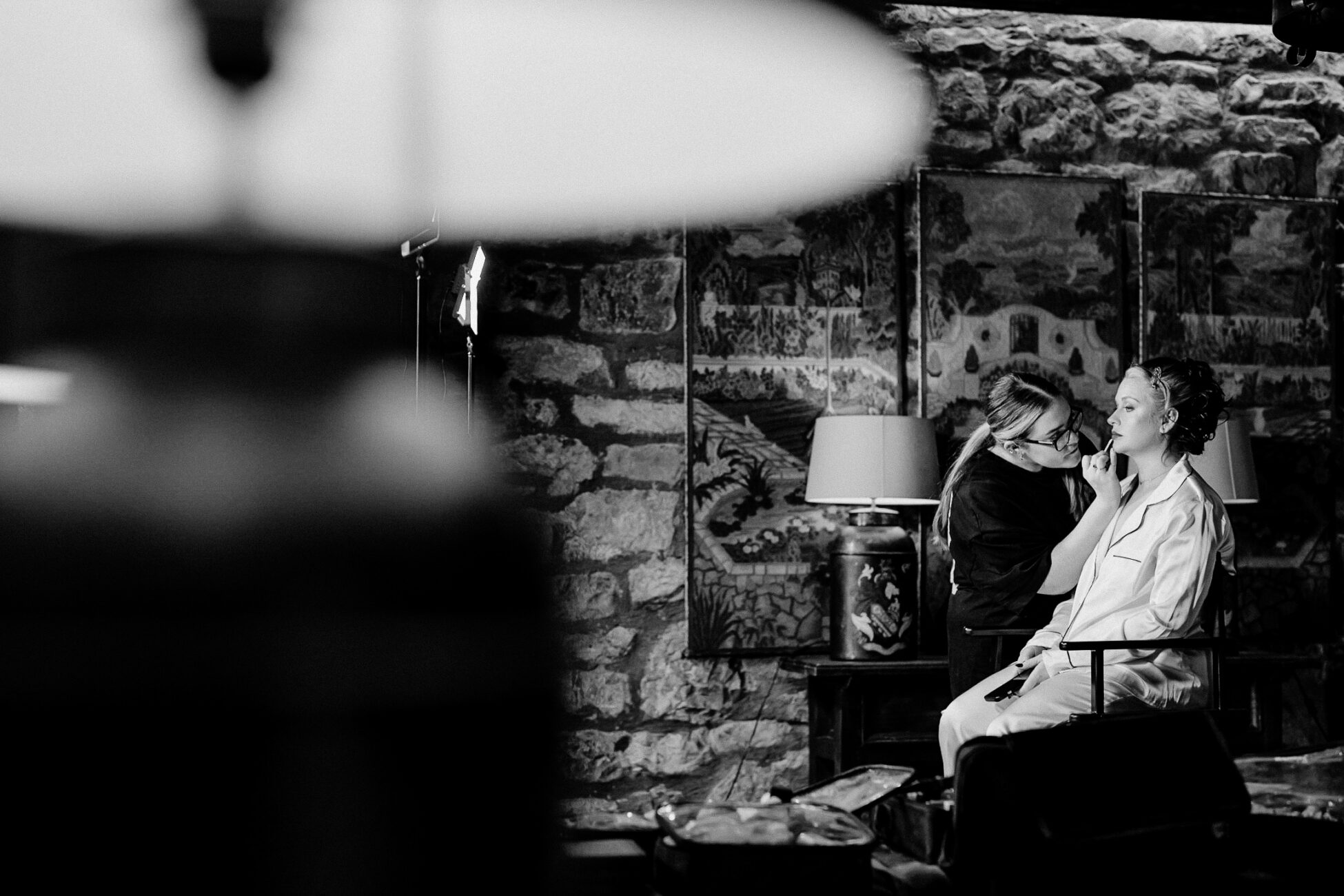 A couple of women sitting in a room with a fireplace