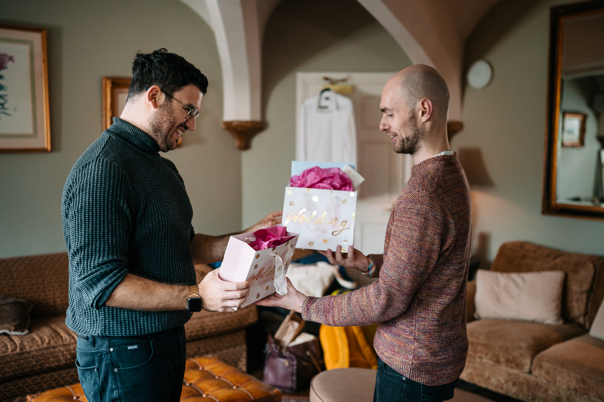 A couple of men holding a cake