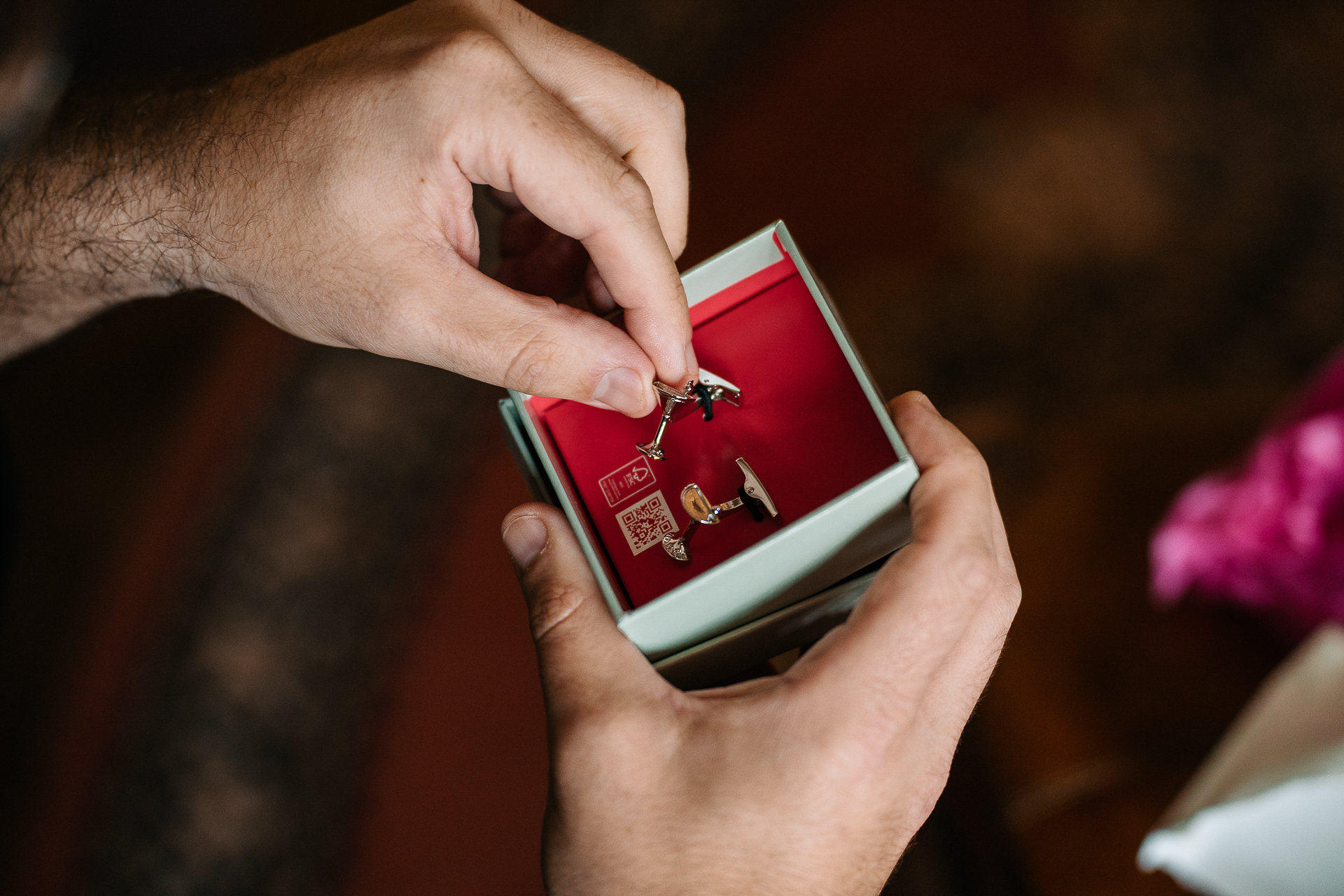 A person holding a small red box