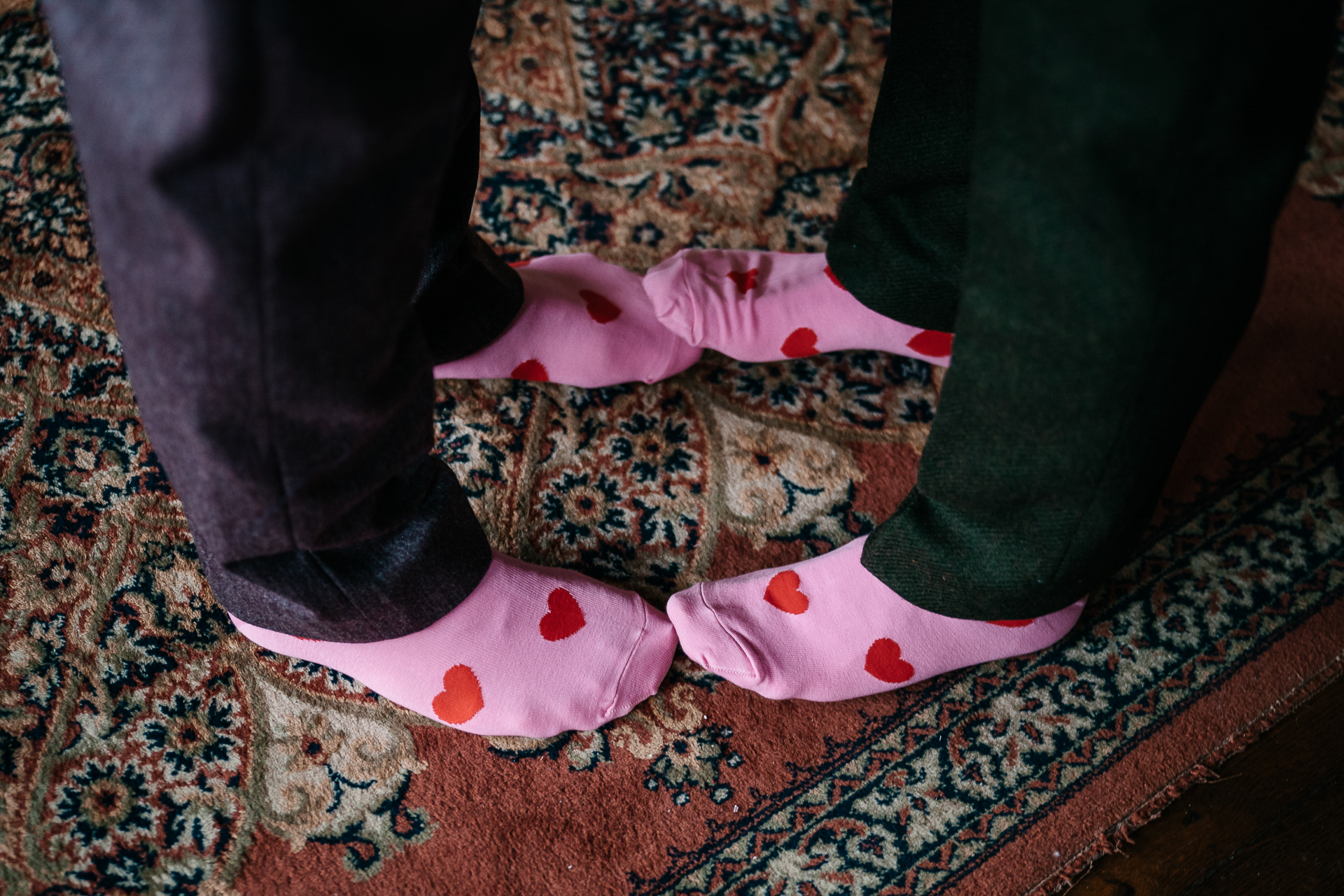 A pair of feet with pink socks