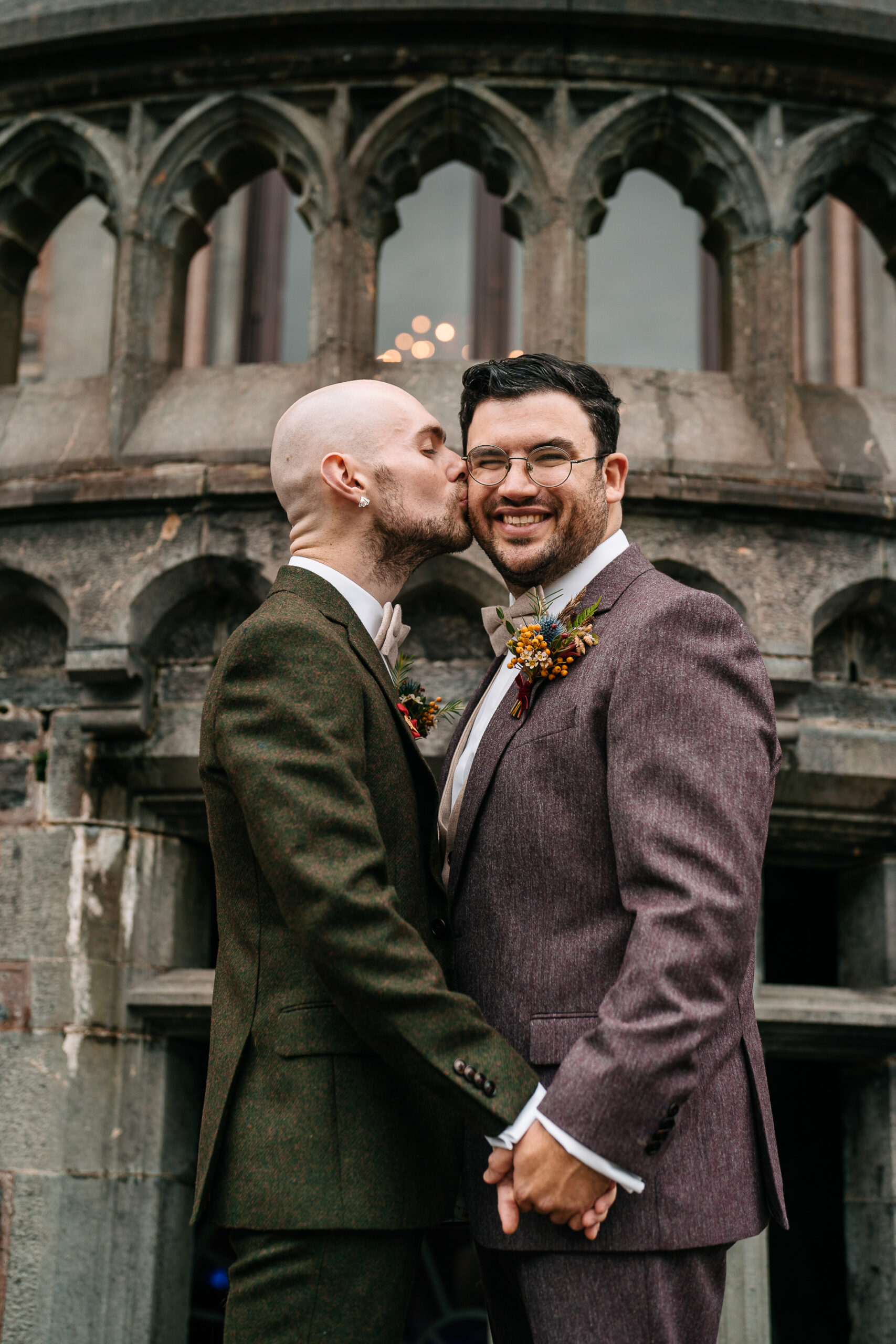 A man kissing another man on the cheek