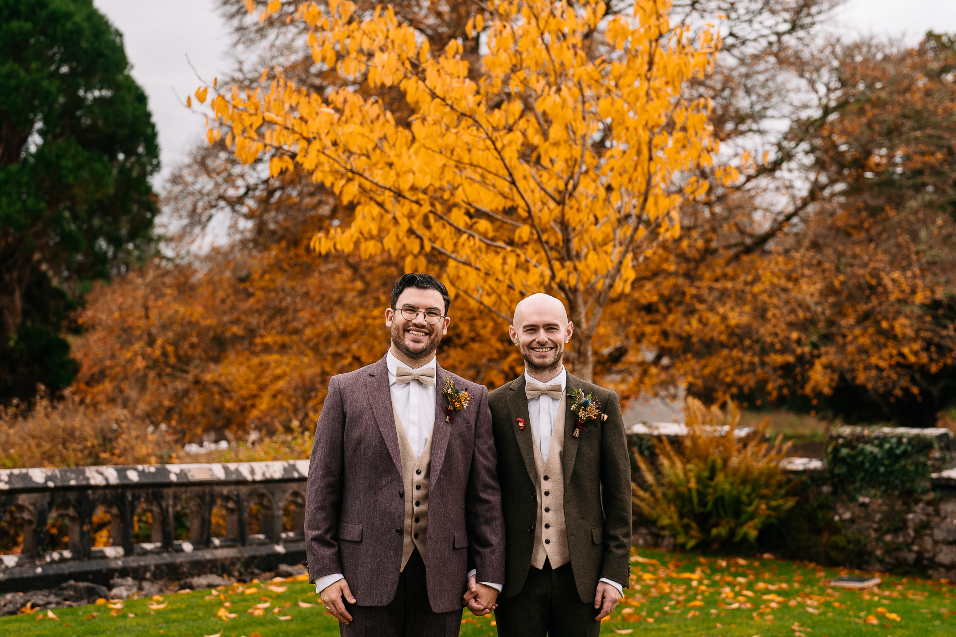 Two men standing in front of a tree