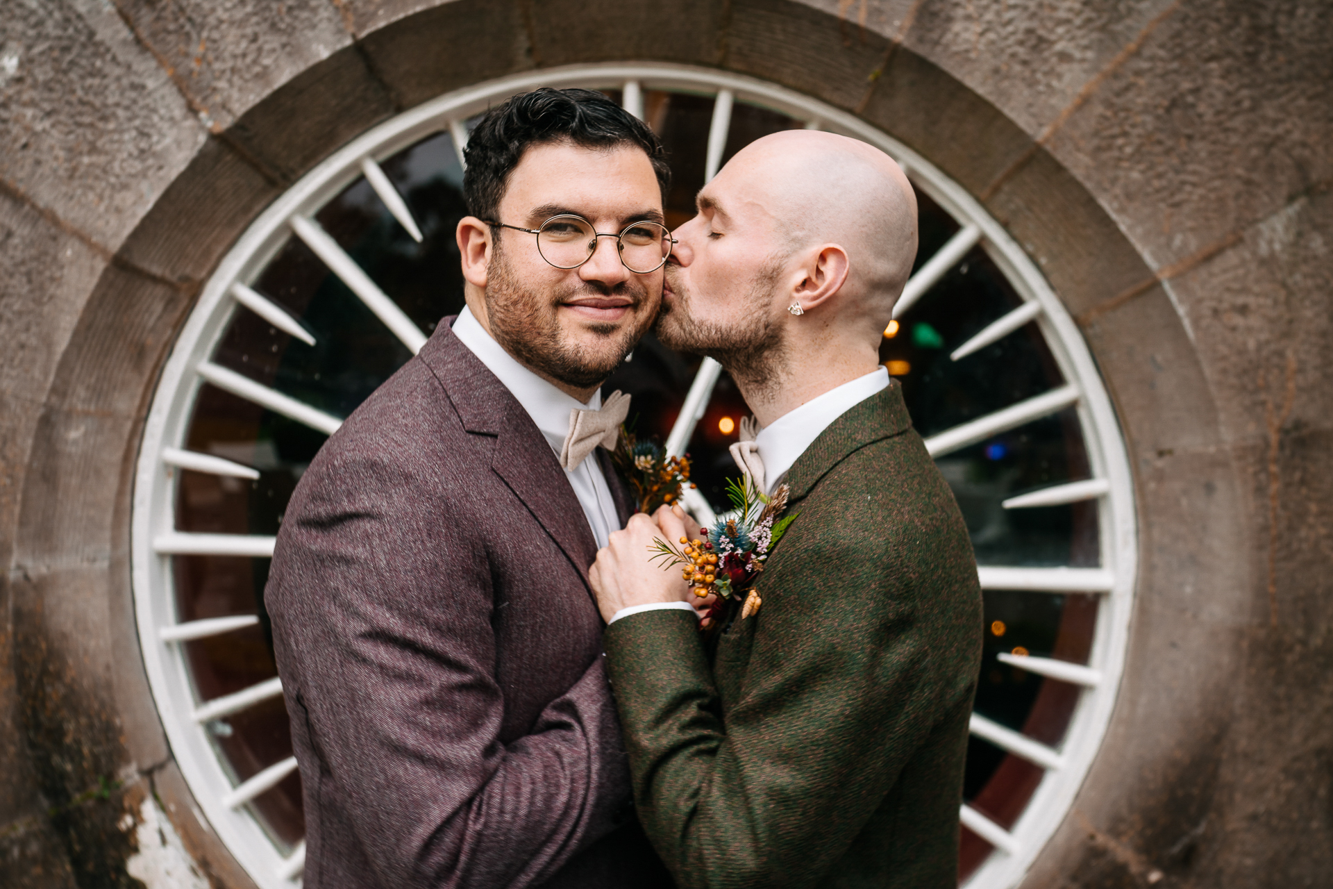 A person in a suit and a person in a suit holding flowers