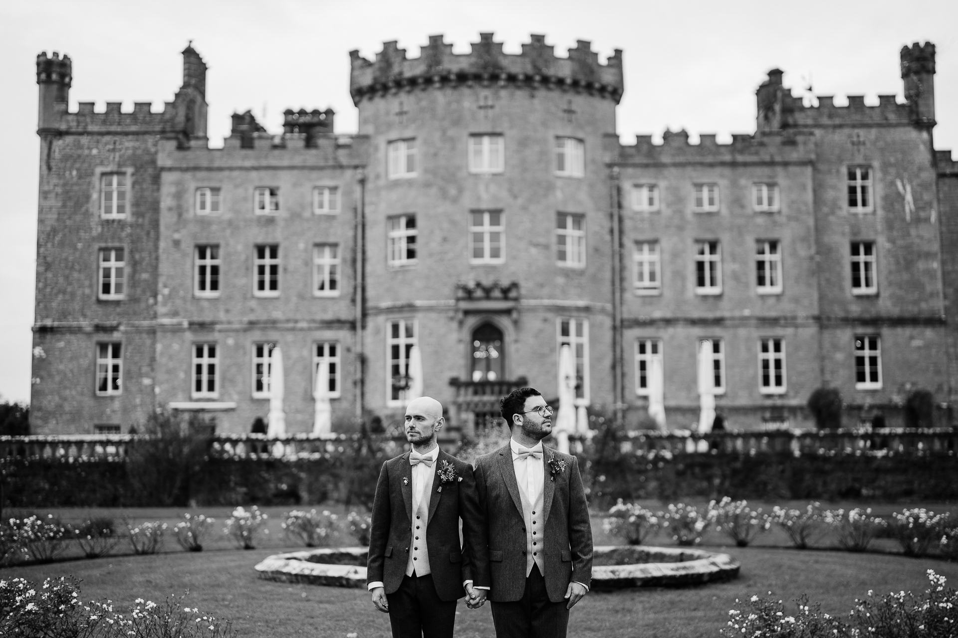 A couple of men standing in front of a building