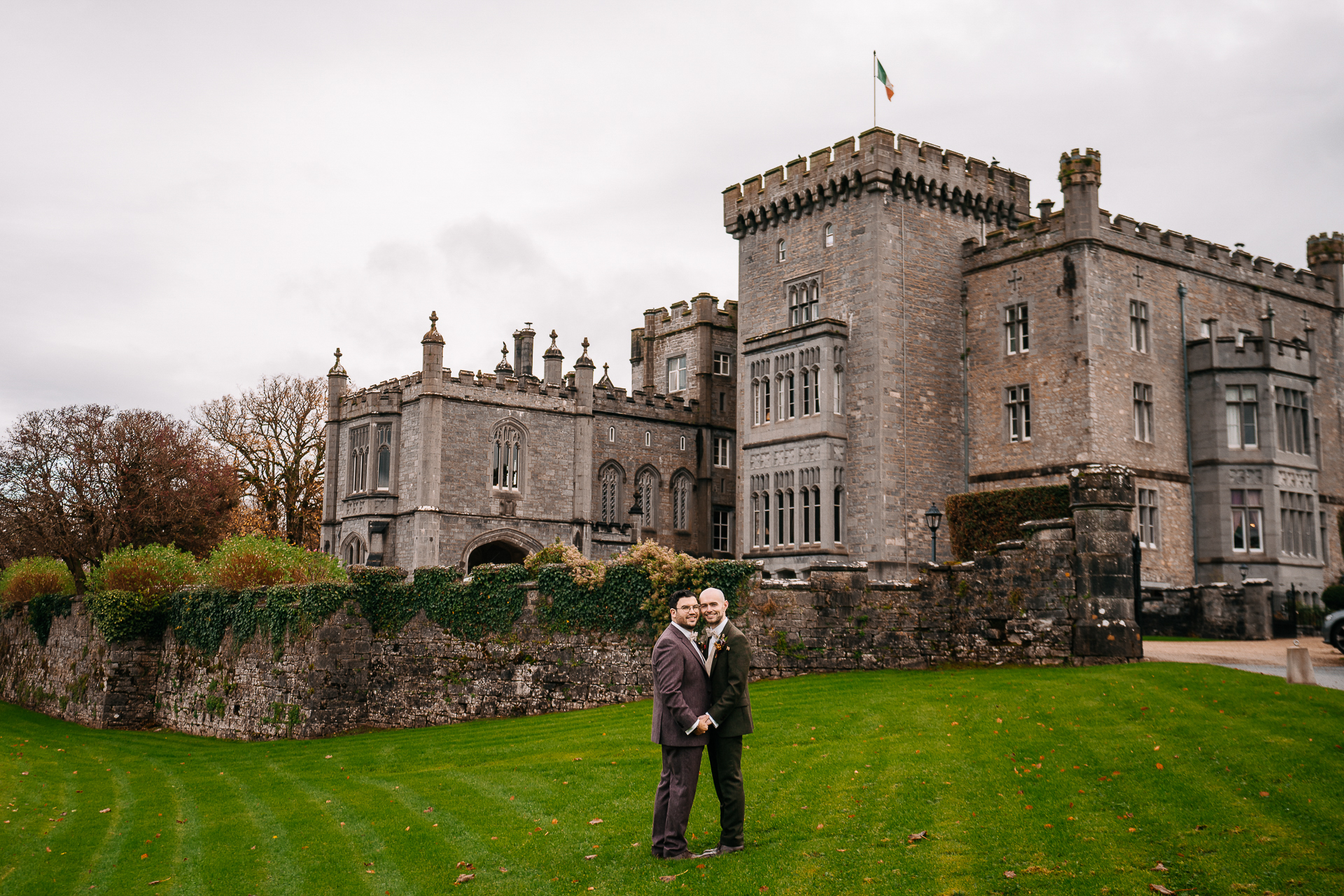 A man and woman standing in front of a castle